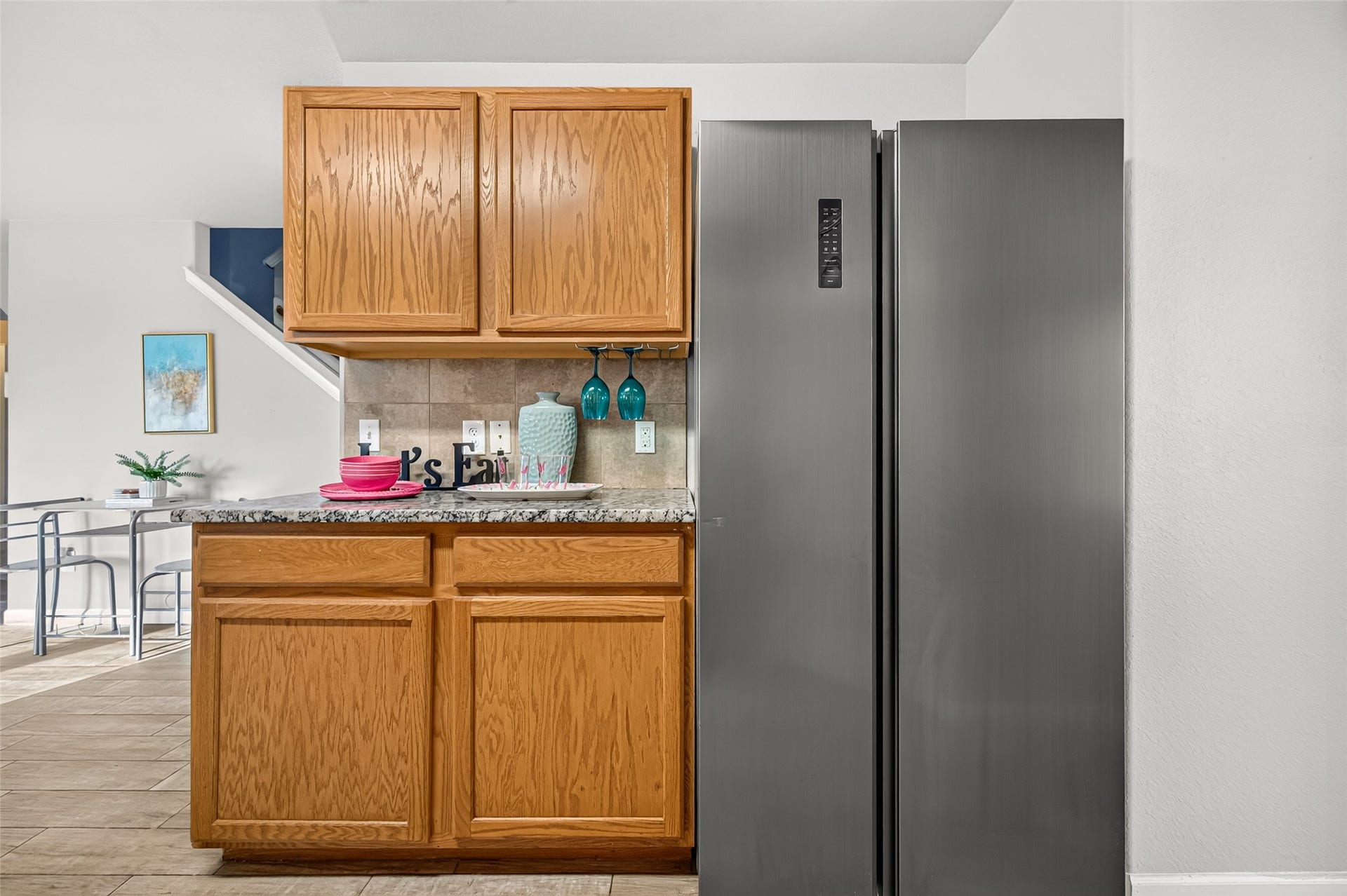 19707 Dayton Springs Drive, Cypress, TX 77429 kitchen space with stainless steel appliances, warm wooden cabinetry, and a granite countertop, perfect for culinary adventures.