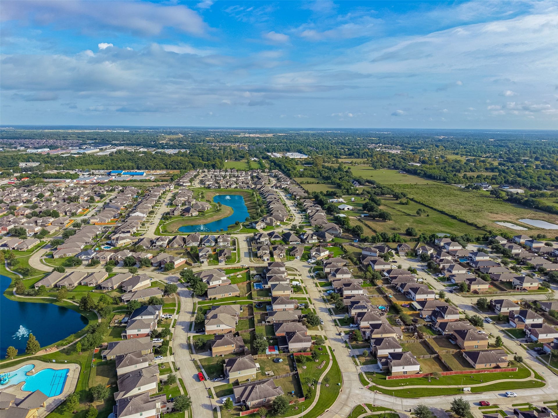 19707 Dayton Springs Drive, Cypress, TX 77429 Charming suburban neighborhood with winding streets, picturesque ponds, and a community pool, offering a serene and family-friendly environment.