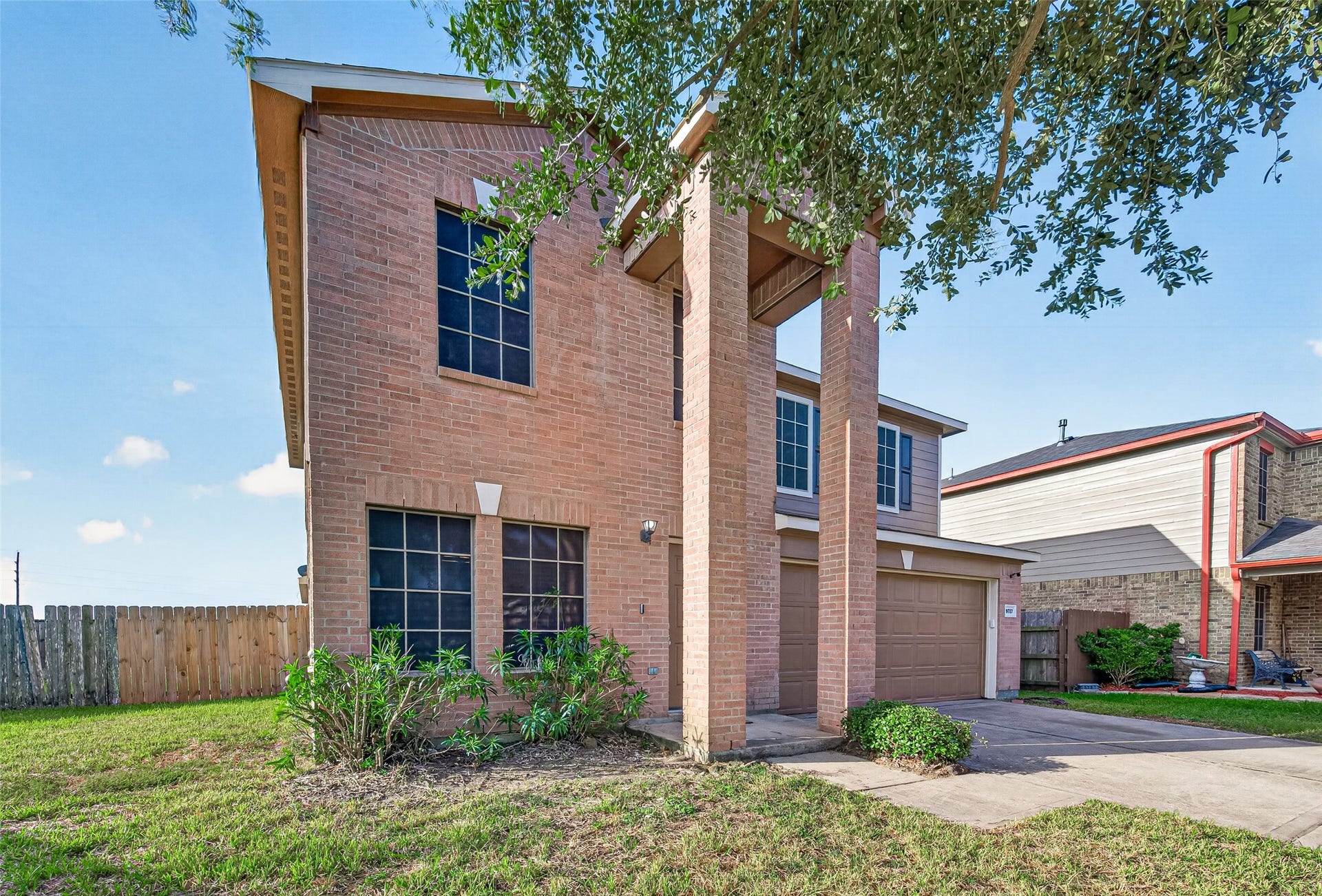 19707 Dayton Springs Drive, Cypress, TX 77429 Charming two-story brick home with elegant tall columns and a spacious two-car garage, nestled in a quiet neighborhood with a fenced backyard.