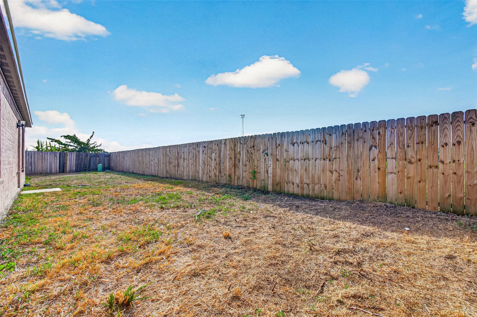 19707 Dayton Springs Drive, Cypress, TX 77429 Spacious fenced backyard offering privacy and potential for landscaping or outdoor activities.