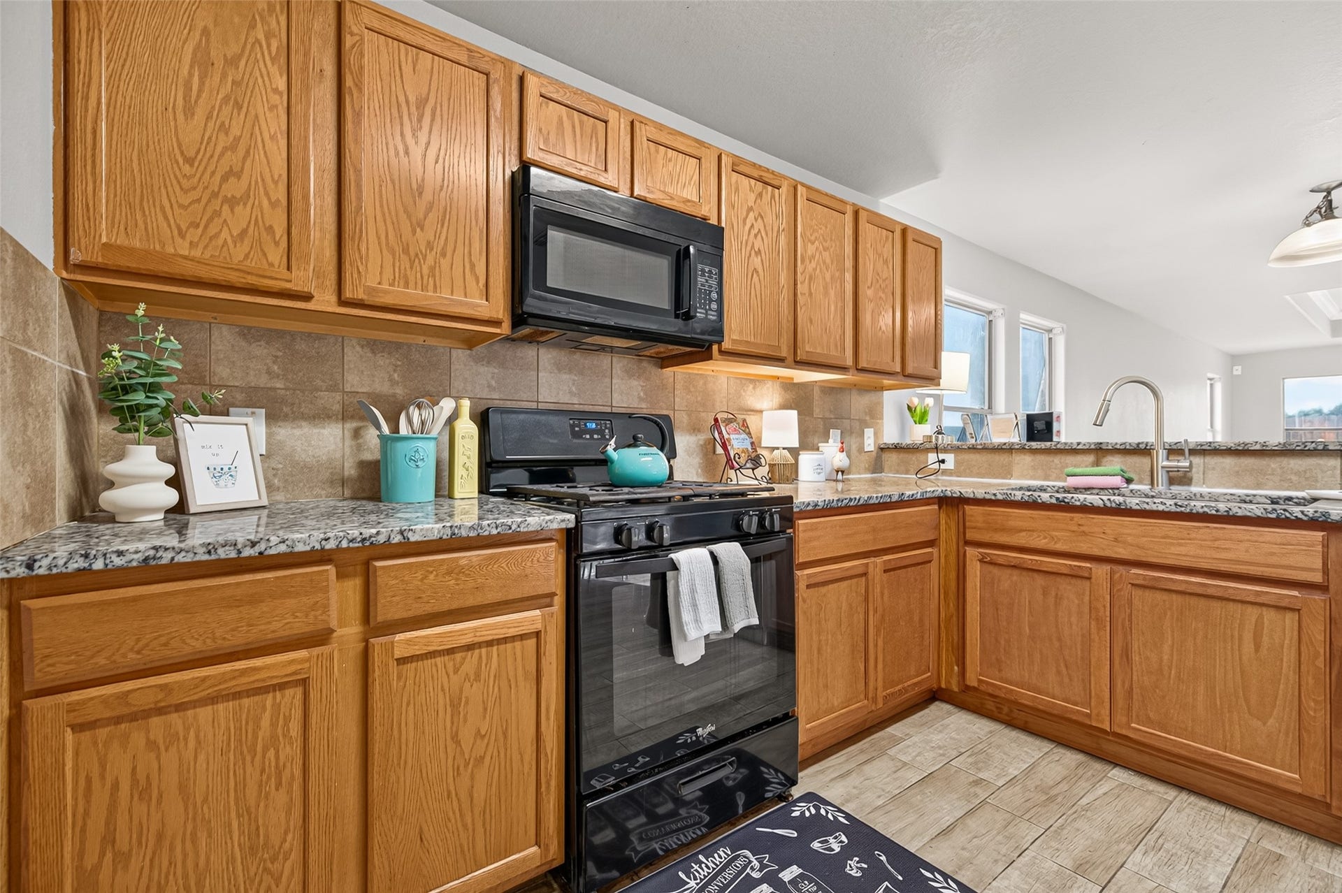 19707 Dayton Springs Drive, Cypress, TX 77429 Spacious kitchen with warm wood cabinetry, granite countertops, appliances, perfect for culinary enthusiasts.