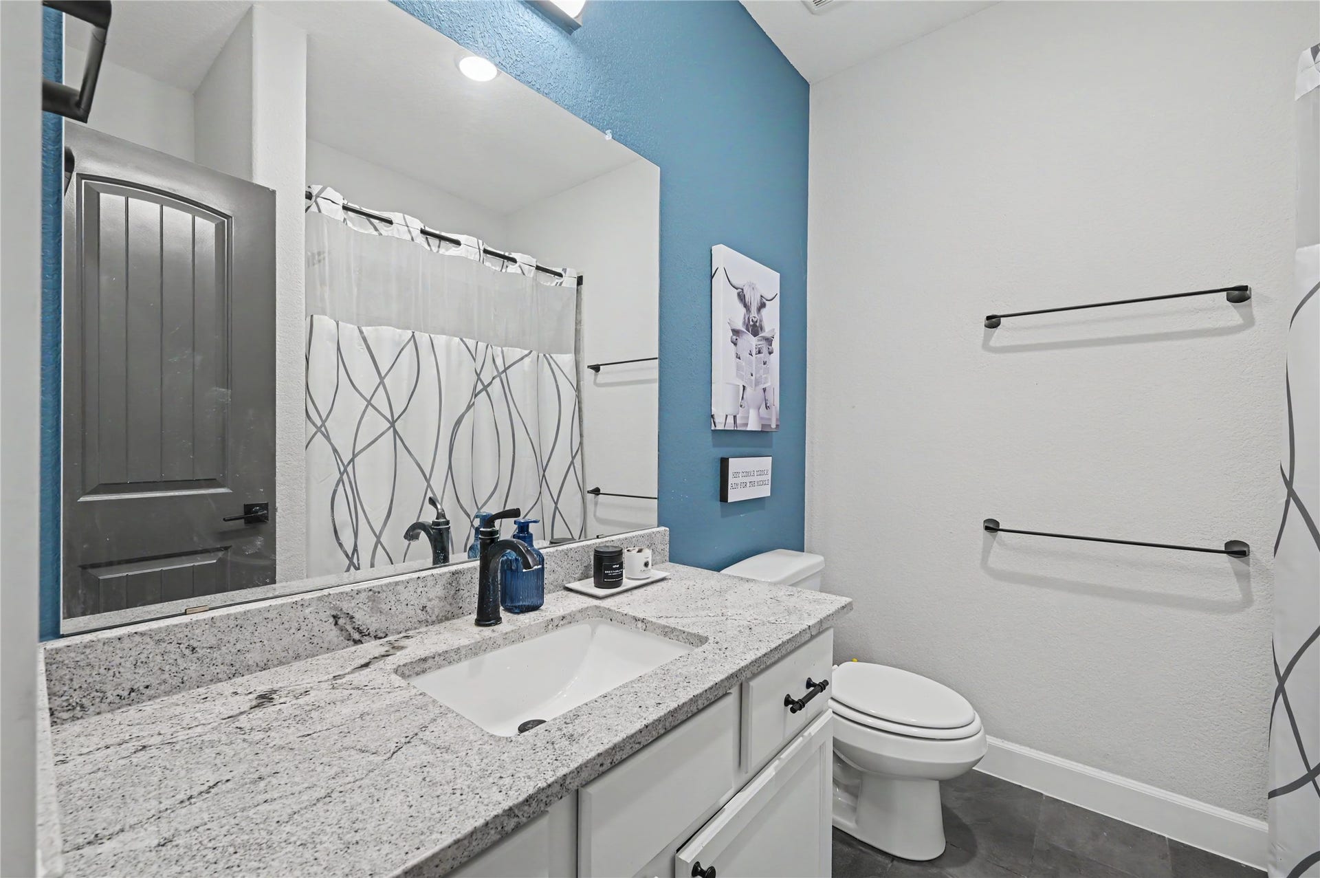The secondary bathroom features a stylish vanity, modern fixtures, and a convenient bathtub and shower combination. Its bright finishes and functional design make this space both attractive and practical for everyday use.