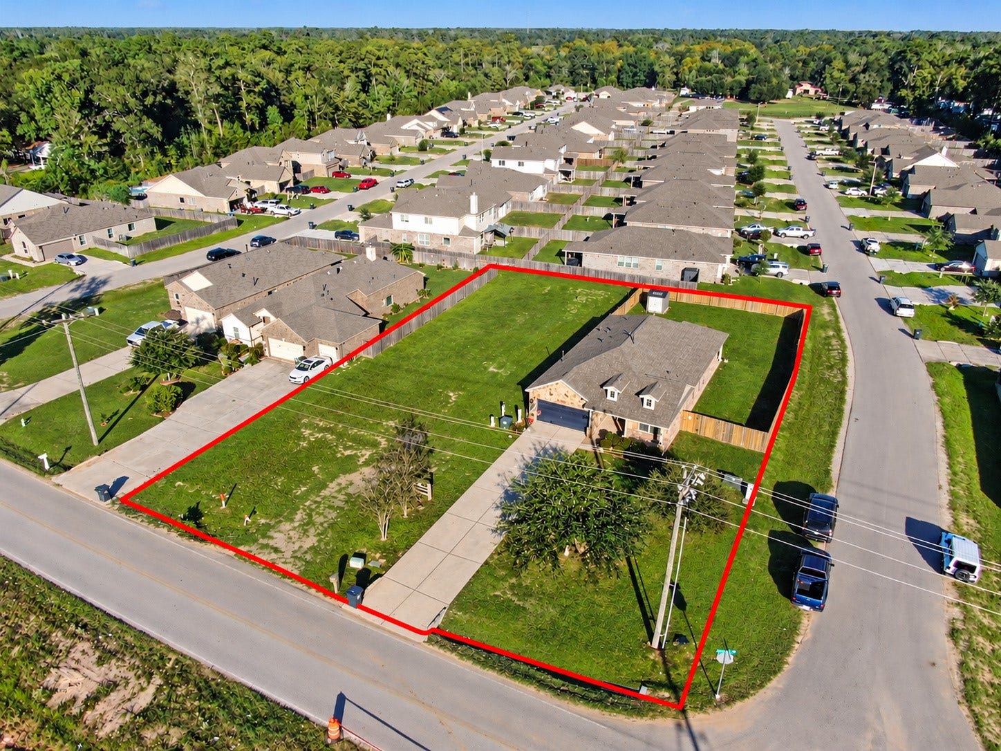 Impressive aerial view highlighting the home's location within an established residential neighborhood. This perspective showcases the property's home and the included lot next to it.