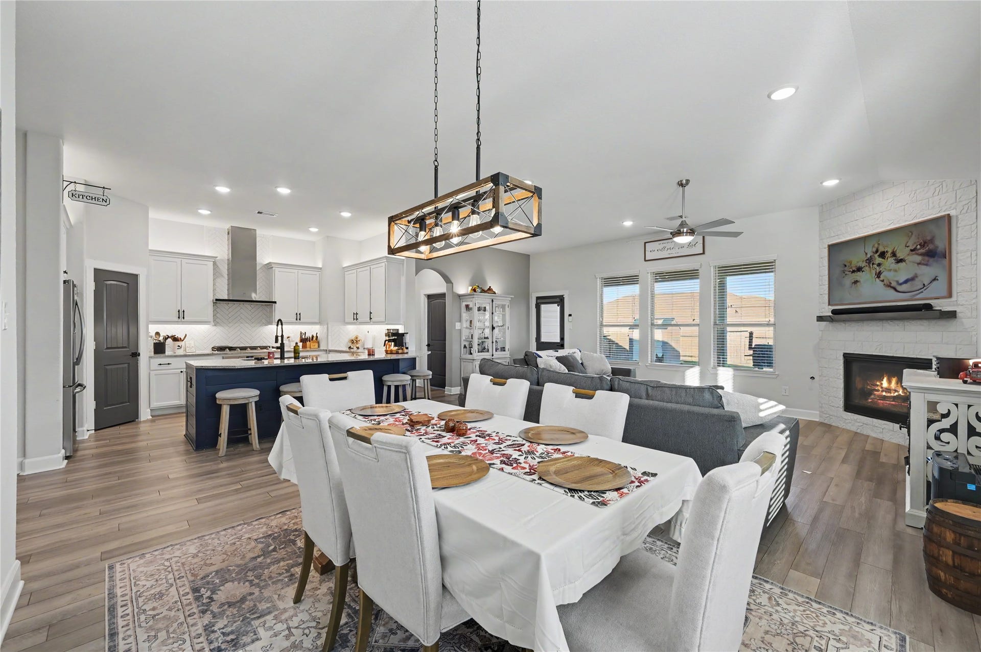 Enjoy a beautifully arranged dining space that flows effortlessly into the kitchen and adjacent living areas. The open-concept design, stylish light fixture, and abundant natural light create an inviting setting for entertaining and everyday dining.