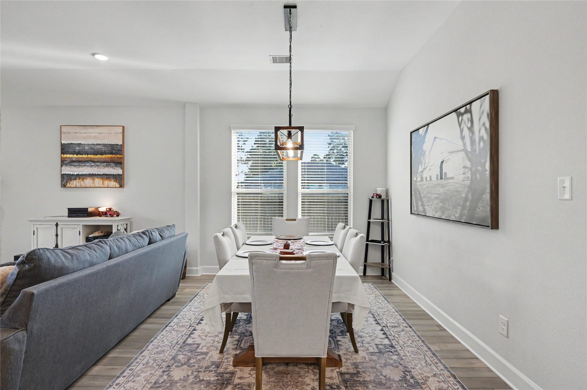This inviting living area offers a seamless connection between the family room, dining space, and kitchen. Beautiful flooring, neutral tones, and abundant natural light create a comfortable atmosphere perfect for everyday living and entertaining.