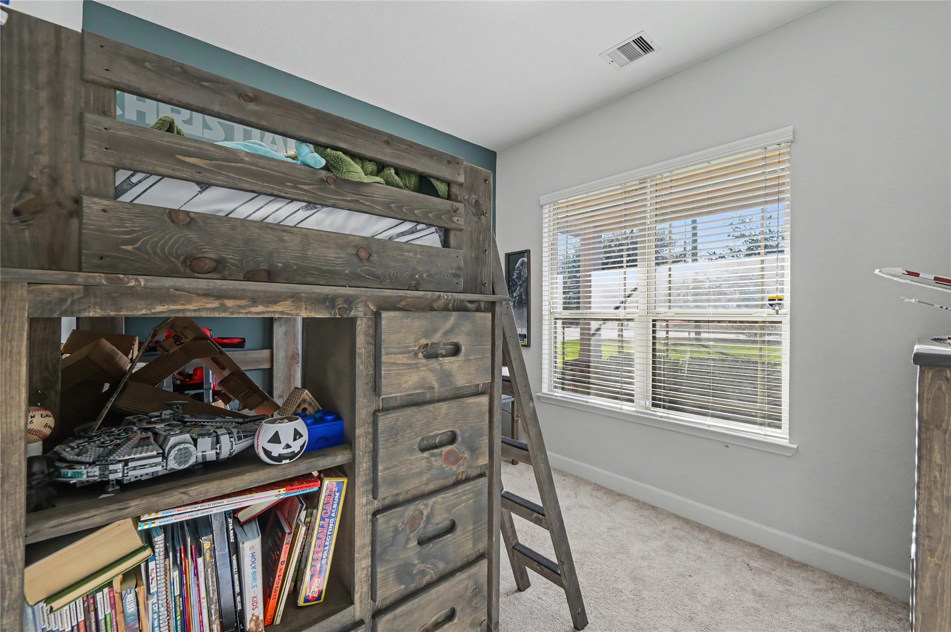 Another view of the secondary bedroom highlights the spacious layout, natural light, and convenient closet area. With neutral finishes and flexible floor space, this room offers comfort and functionality for everyday living.