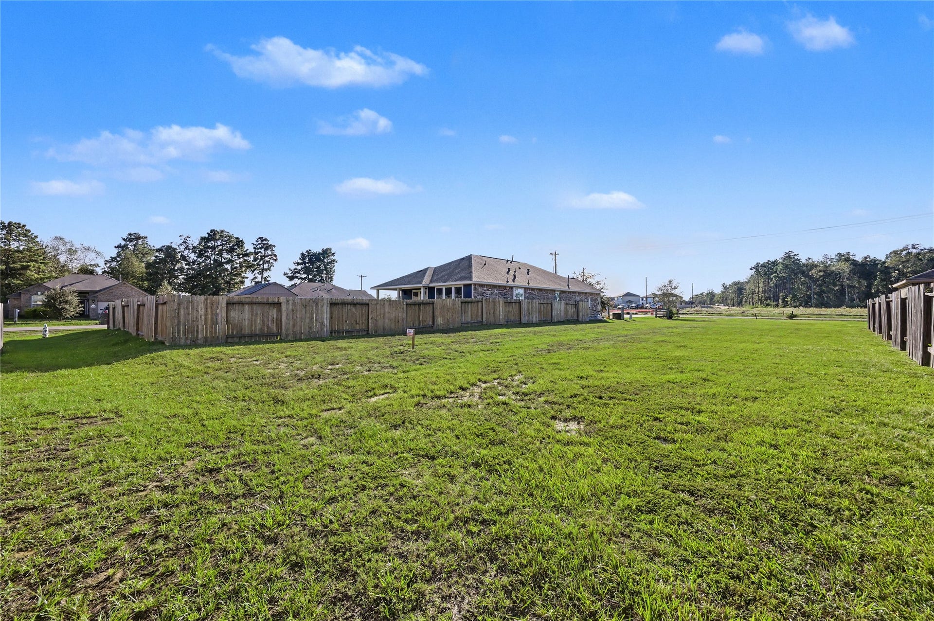 Enjoy an expansive lot with plenty of room to spread out and make the space your own. The open grassy area offers flexibility for outdoor furniture, recreational activities, or future landscaping possibilities.