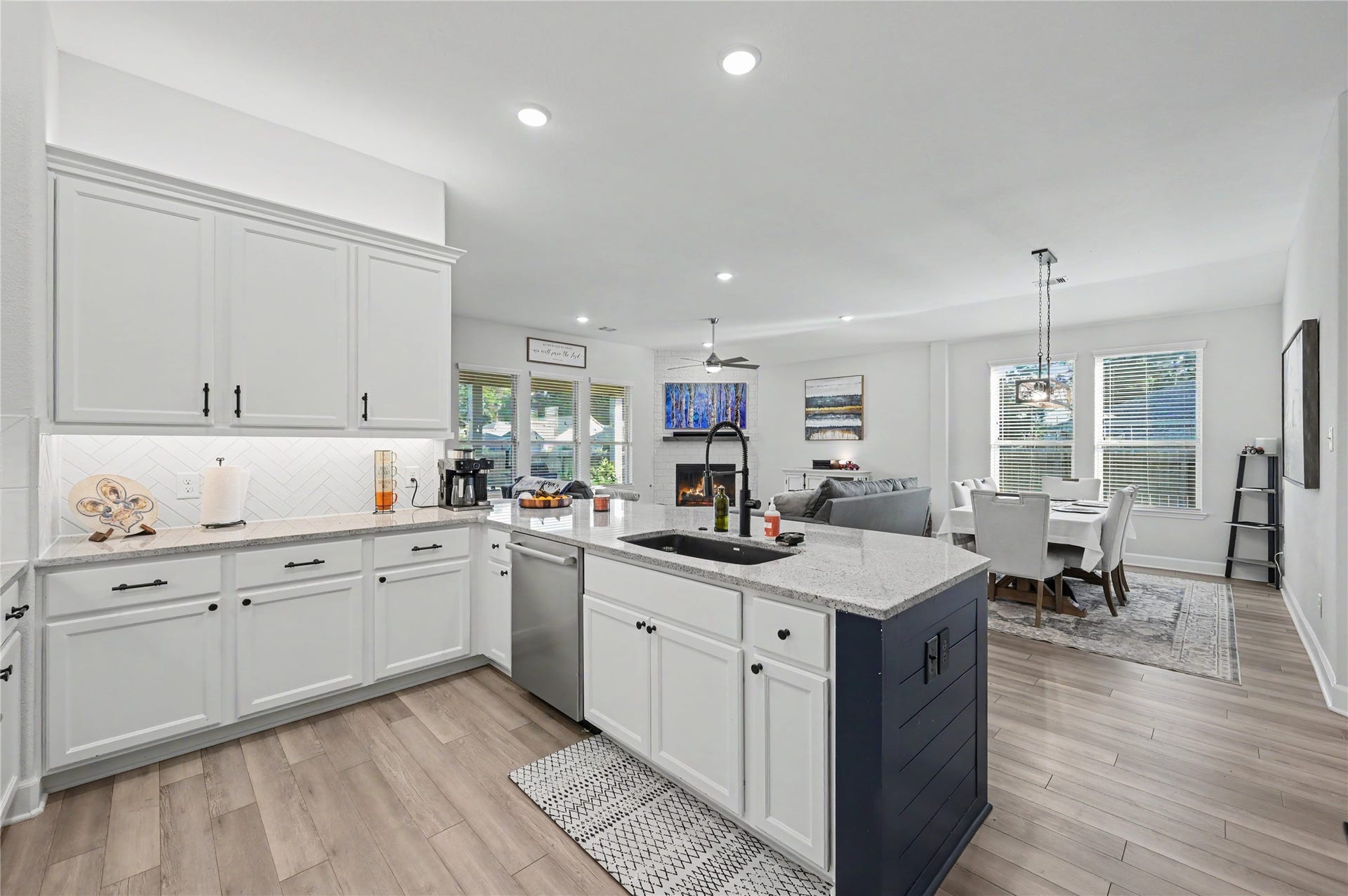 The stunning kitchen offers abundant cabinetry, expansive countertops, and a large center island that serves as the heart of the space. Bright finishes, recessed lighting, and a seamless connection to the surrounding living areas make this kitchen as practical as it is beautiful.