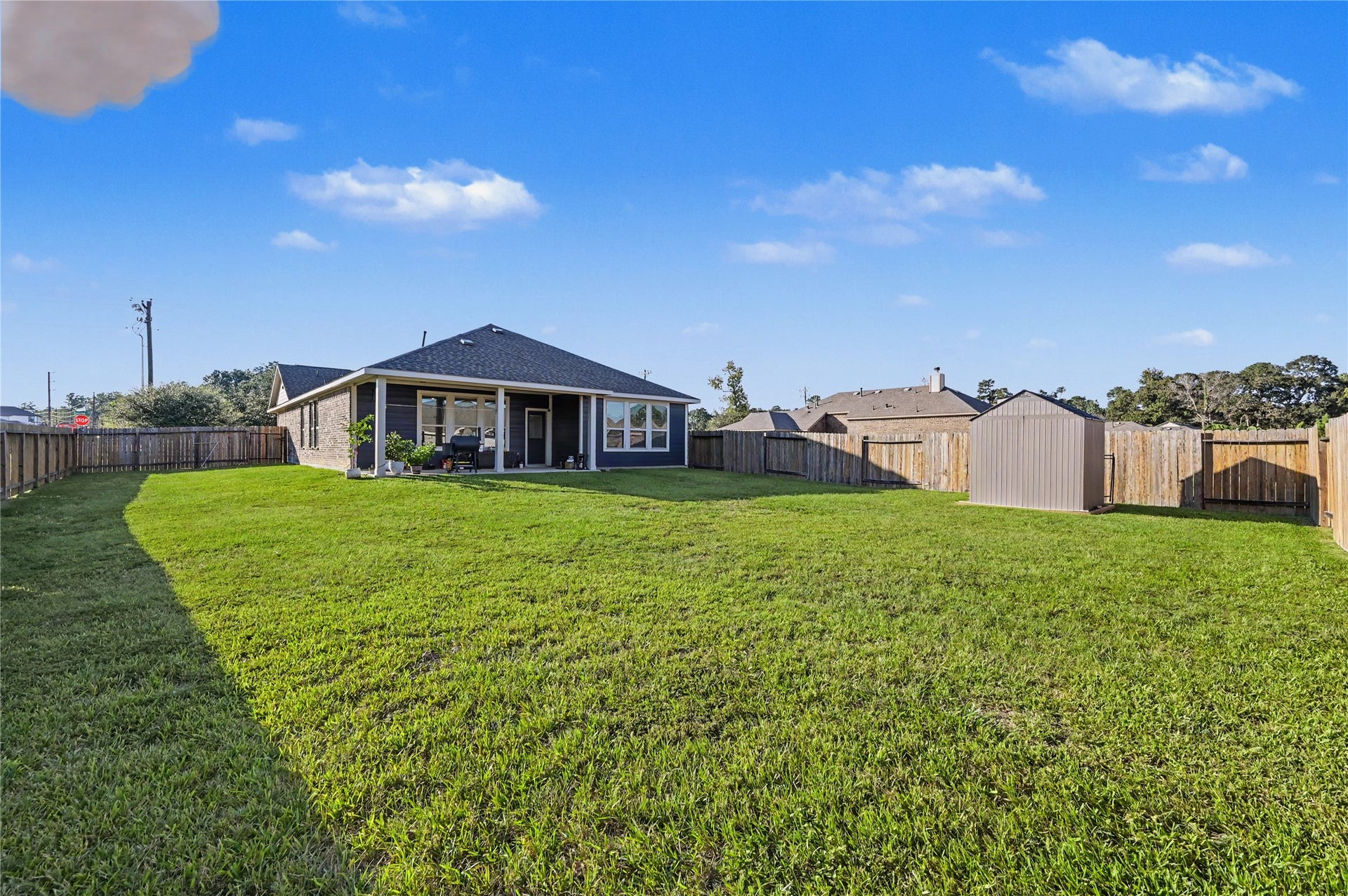 Enjoy a beautiful view of the expansive backyard, featuring a wide-open grassy lawn and plenty of room for outdoor enjoyment. The spacious setting offers wonderful possibilities for entertaining, recreation, or creating your own outdoor retreat.