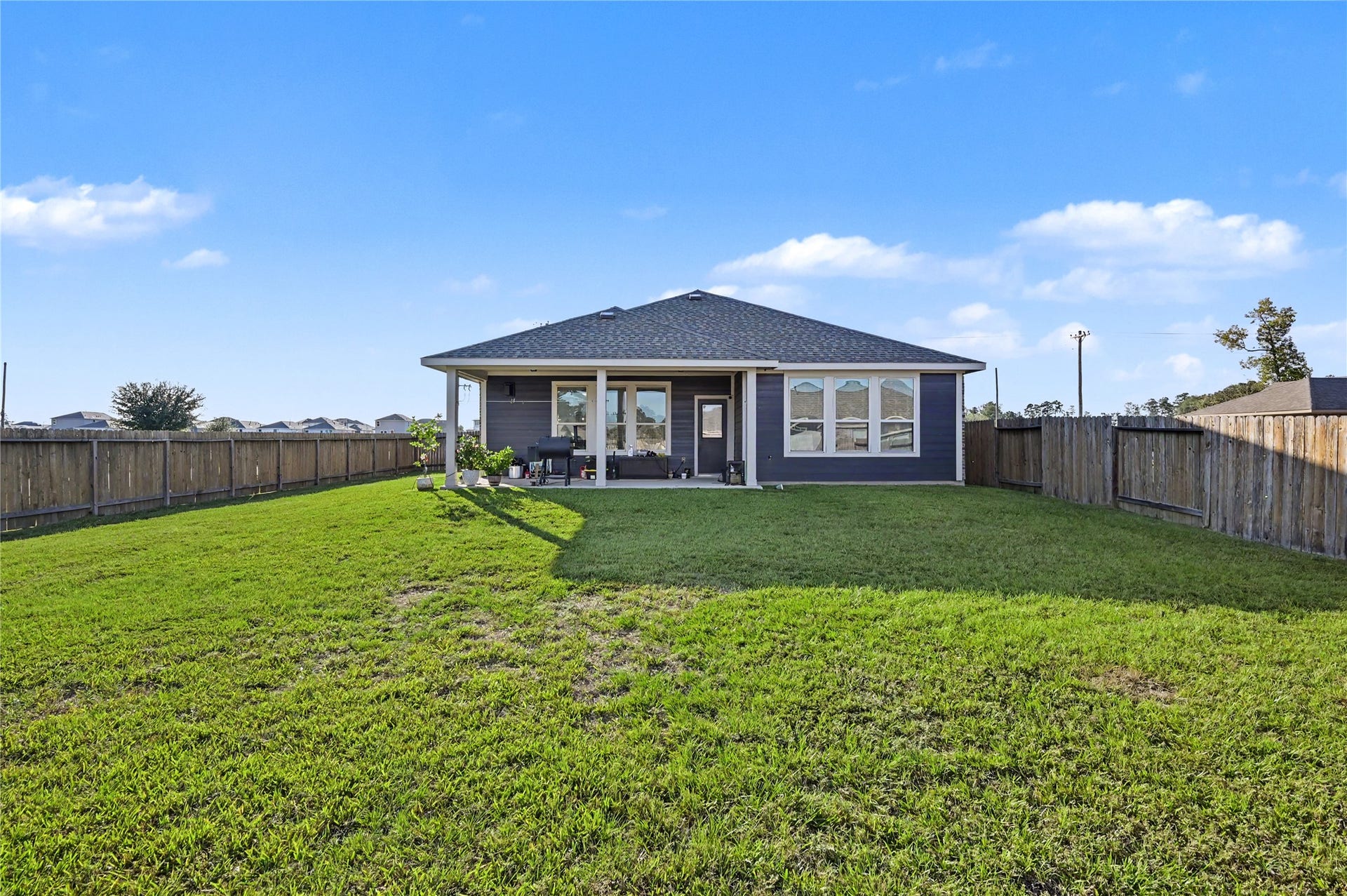 Take in the wide-open views of this generously sized backyard, offering plenty of space to enjoy the outdoors. The expansive grassy lawn provides a wonderful setting for gatherings, outdoor activities, or creating your own backyard retreat.