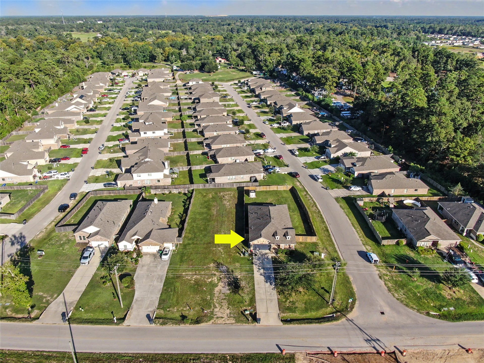 This elevated aerial perspective showcases the home's location within a thoughtfully arranged residential neighborhood. The surrounding streets, neighboring properties, and open green spaces provide a helpful overview of the community's layout.