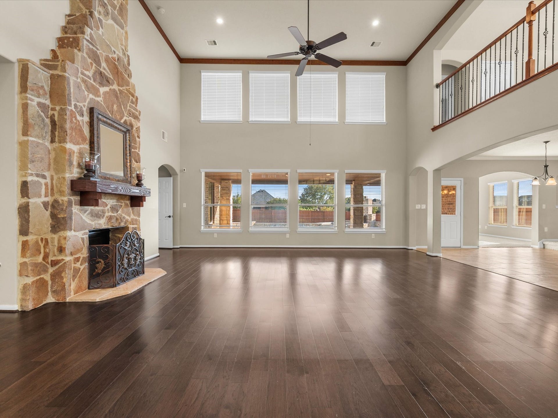 10458 Waterstone Estates Court, Tomball, TX 77375 A beautiful gas-log stone fireplace anchors the living room, which flows naturally into the kitchen and breakfast nook for effortless connection between everyday living spaces.