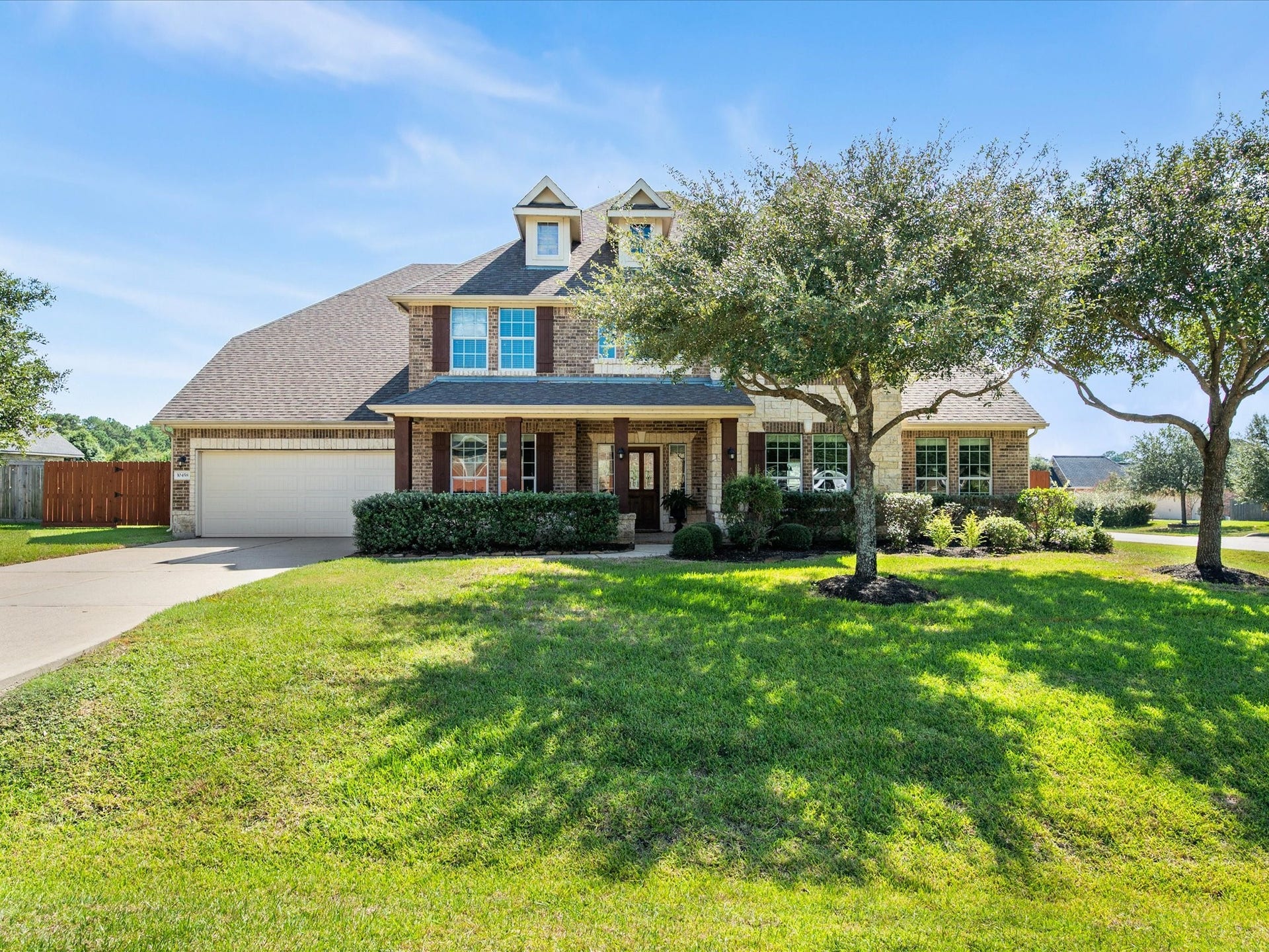 10458 Waterstone Estates Court, Tomball, TX 77375 Timeless brick architecture and an impressive presence introduce a home where generous proportions and inviting spaces await inside.