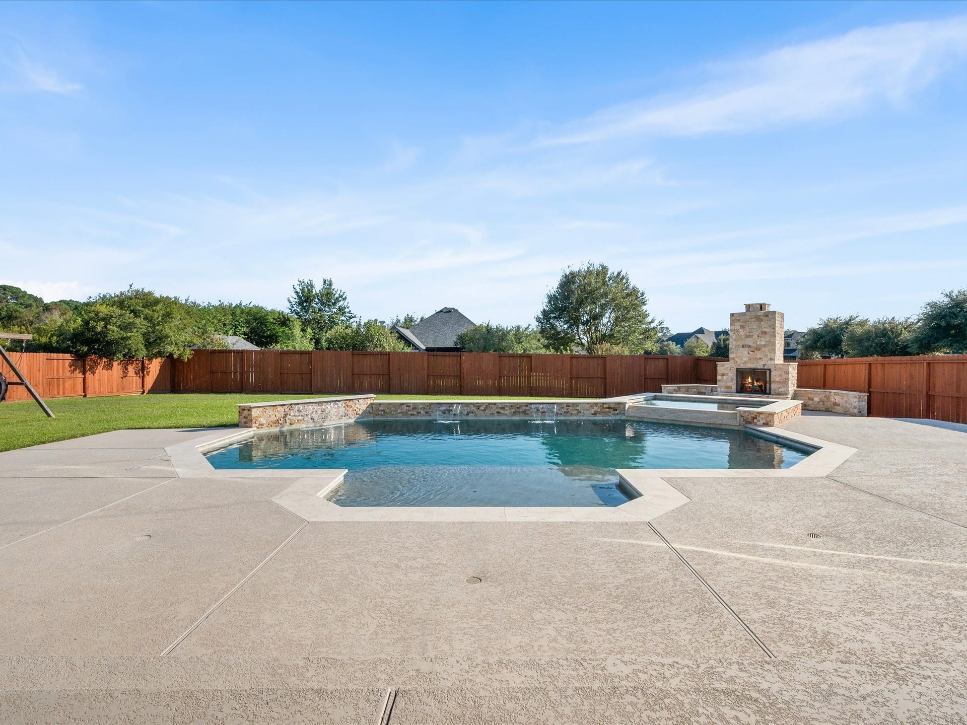 10458 Waterstone Estates Court, Tomball, TX 77375 Made for Texas living, this exceptional outdoor space brings together an expansive covered patio, sparkling pool, oversized spa, and outdoor fireplace on over half an acre.