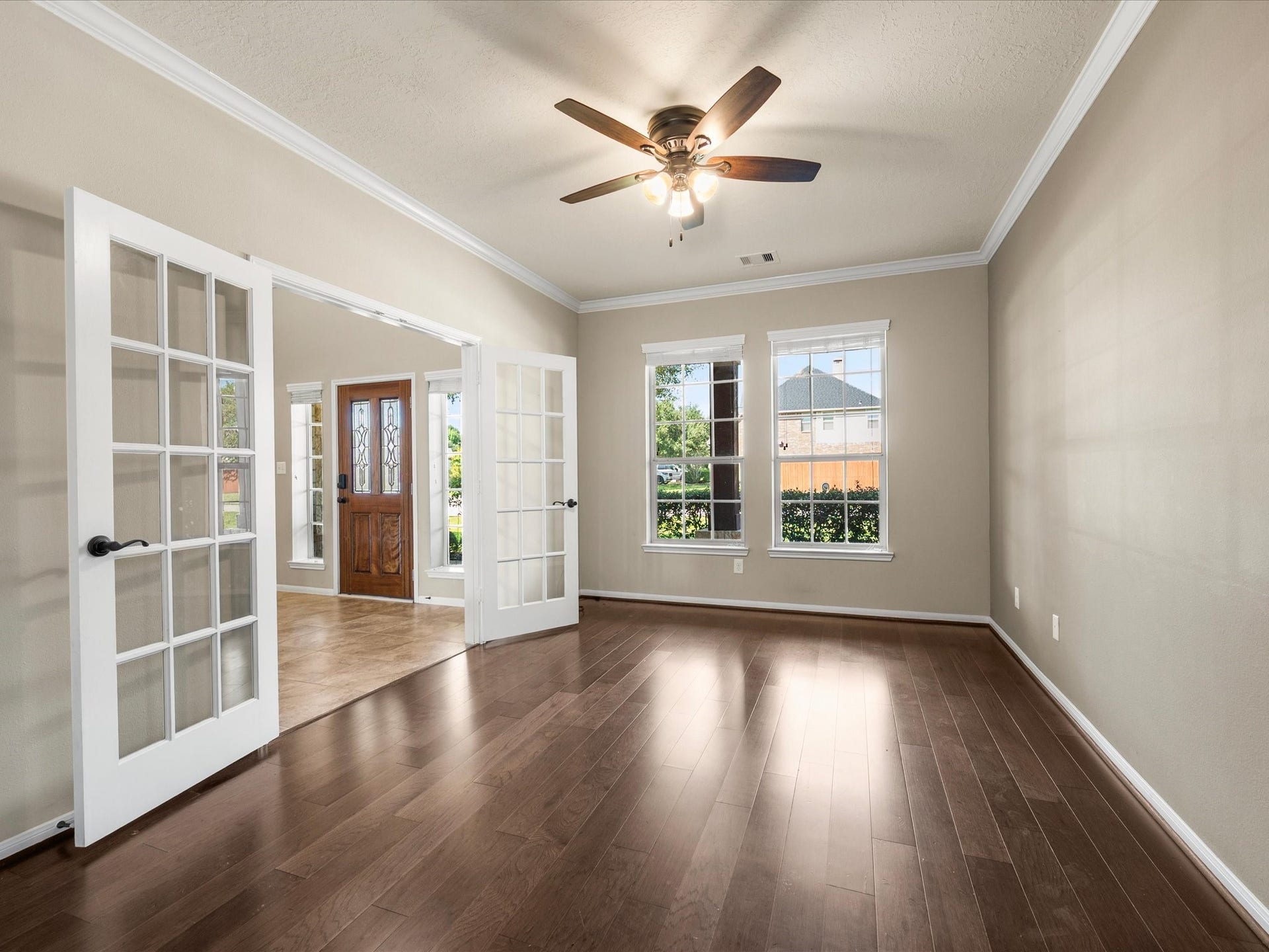 10458 Waterstone Estates Court, Tomball, TX 77375 French doors and generous windows bring natural light into this versatile space, offering a peaceful place to focus, enjoy a favorite book, or welcome overnight guests.