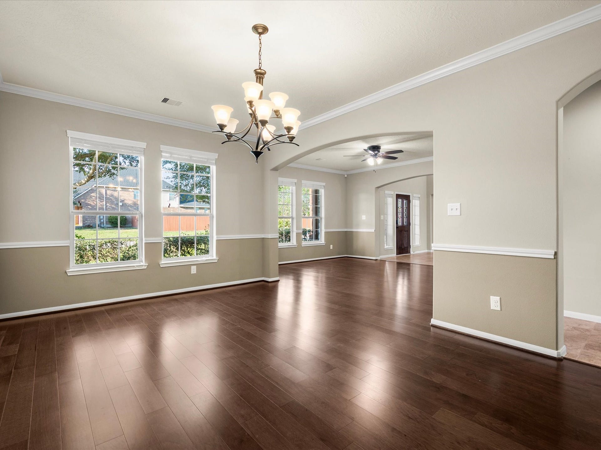 10458 Waterstone Estates Court, Tomball, TX 77375 Crown molding, classic chair railing, and gleaming wood floors lend timeless character to the formal dining room, which opens toward the formal living room and grand entryway.