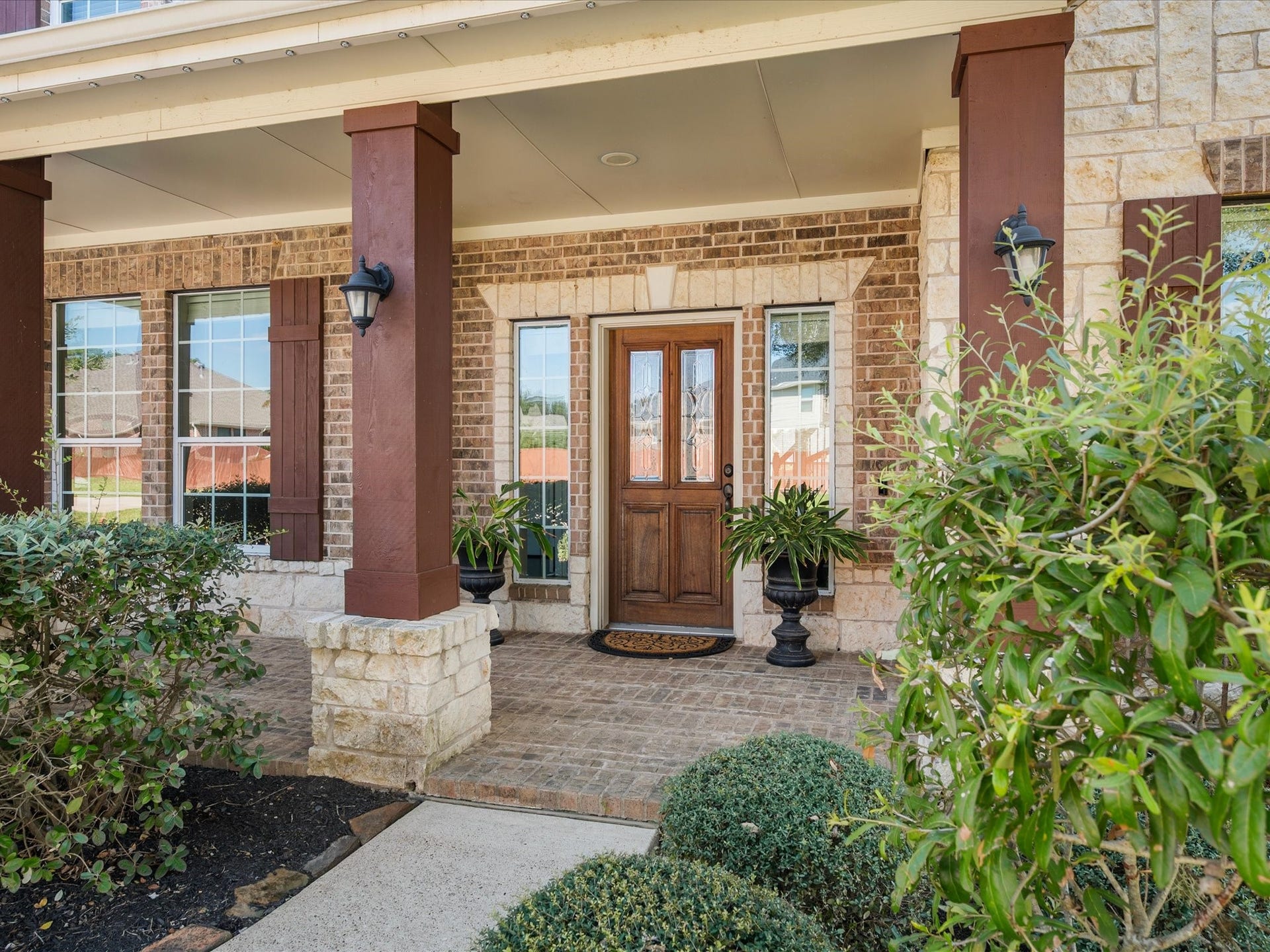 10458 Waterstone Estates Court, Tomball, TX 77375 Architectural details and classic brickwork give the home's exterior a timeless character, complemented by mature landscaping and a welcoming approach.