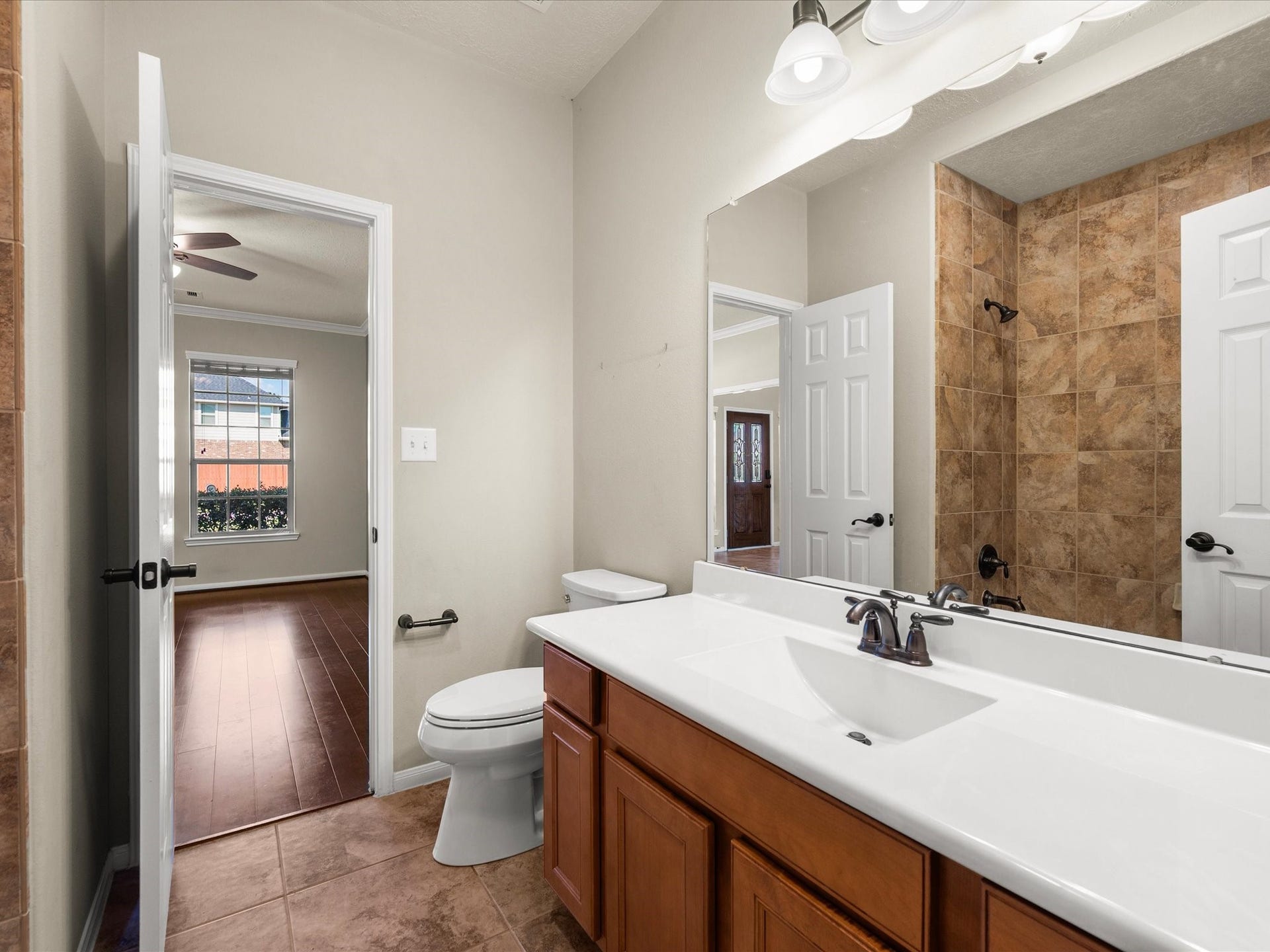 10458 Waterstone Estates Court, Tomball, TX 77375 A full bathroom just off the home office adds convenience and flexibility, making the adjoining room especially well-suited for guests or extended household needs.