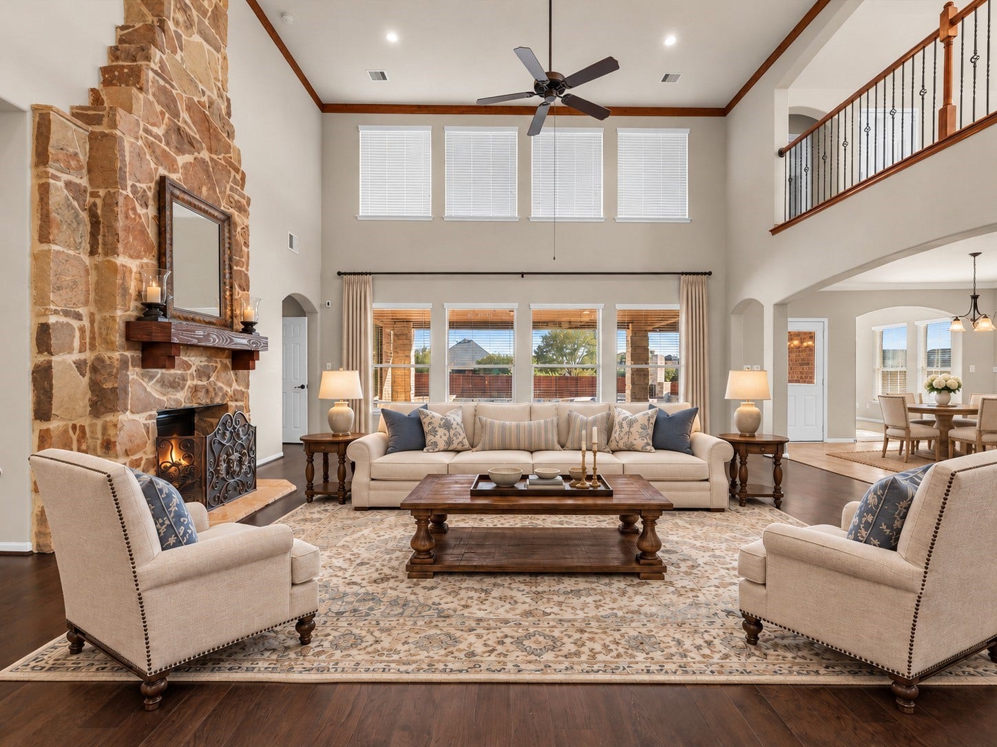 10458 Waterstone Estates Court, Tomball, TX 77375 Virtually staged to help envision the possibilities, this expansive living room offers room to gather with loved ones, settle in for a cozy evening, or entertain against the backdrop of soaring ceilings and a striking stone fireplace.