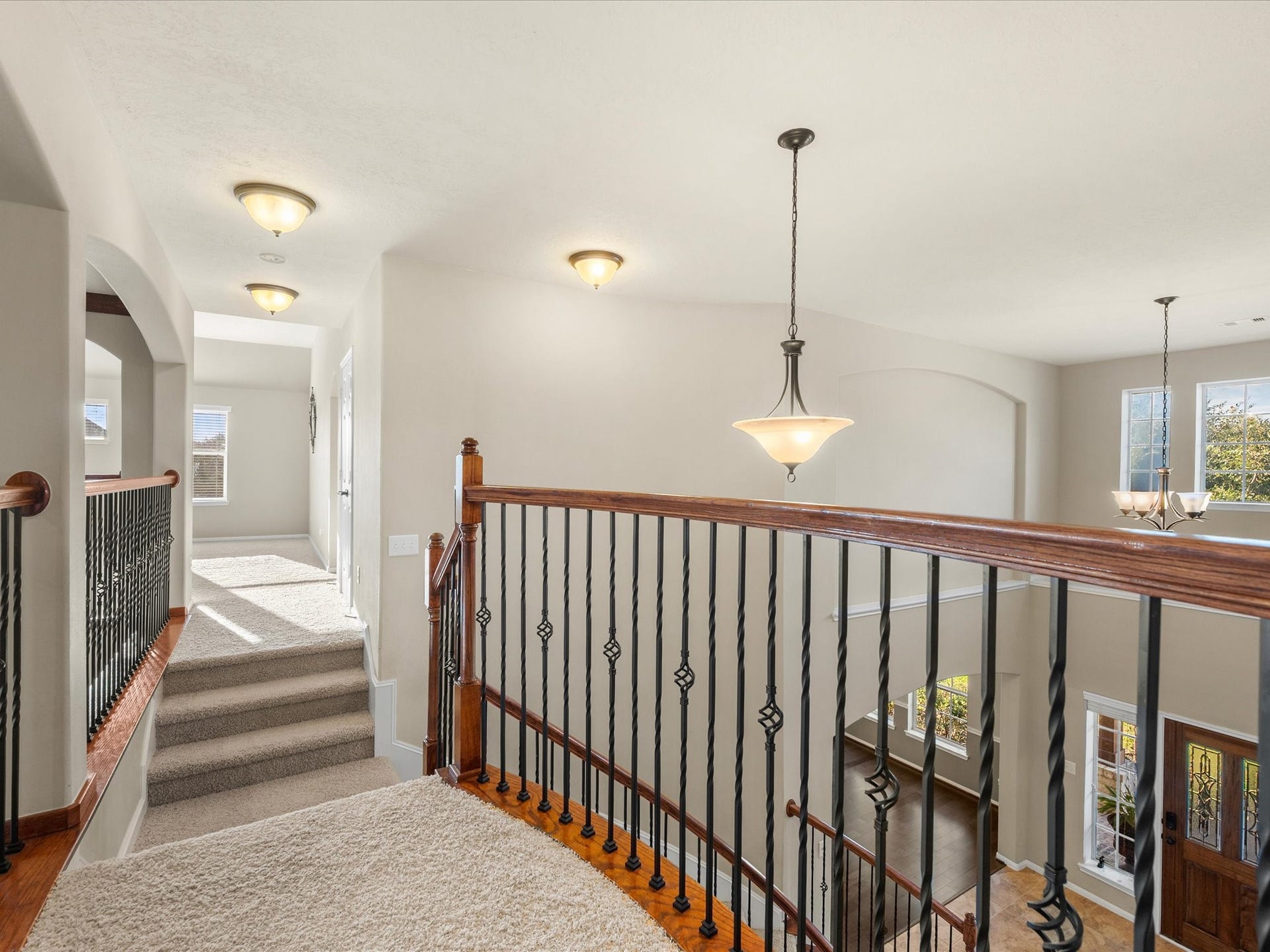 10458 Waterstone Estates Court, Tomball, TX 77375 An elegant upstairs gallery balcony connects the second-story spaces while overlooking the grand entryway and living room below, creating a beautiful architectural focal point.