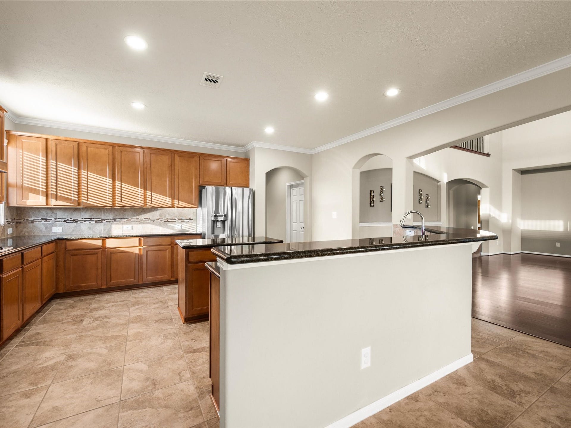 10458 Waterstone Estates Court, Tomball, TX 77375 The kitchen opens seamlessly to the living room and breakfast nook, creating an inviting flow that keeps conversation and connection at the center of everyday living.