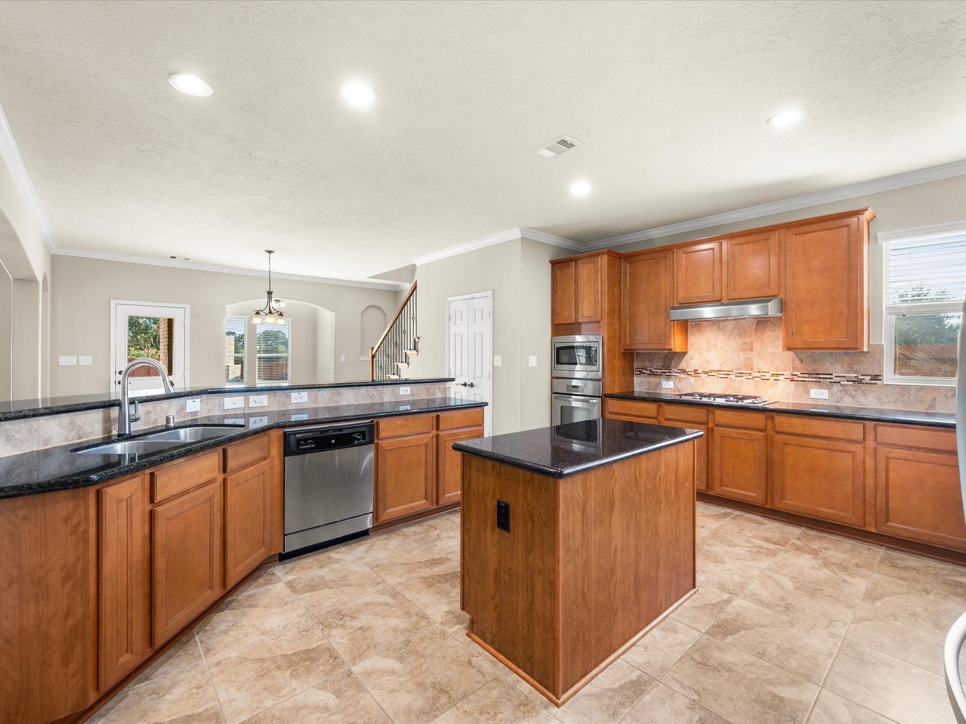 10458 Waterstone Estates Court, Tomball, TX 77375 With generous counterspace, abundant storage, and a central island, this expansive kitchen offers room to prepare favorite recipes, gather over casual meals, and make everyday moments feel special.