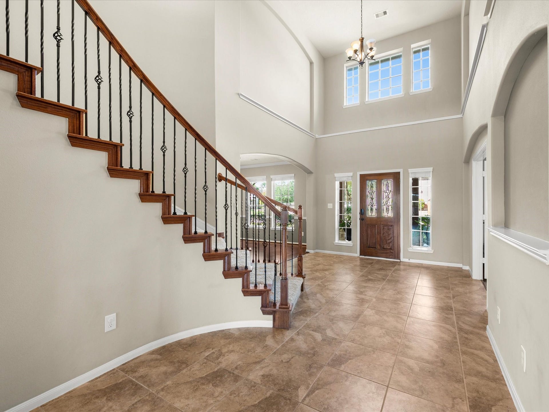 10458 Waterstone Estates Court, Tomball, TX 77375 Natural light fills the entryway, highlighting the rich crown molding and meticulously maintained finishes that carry throughout the home.