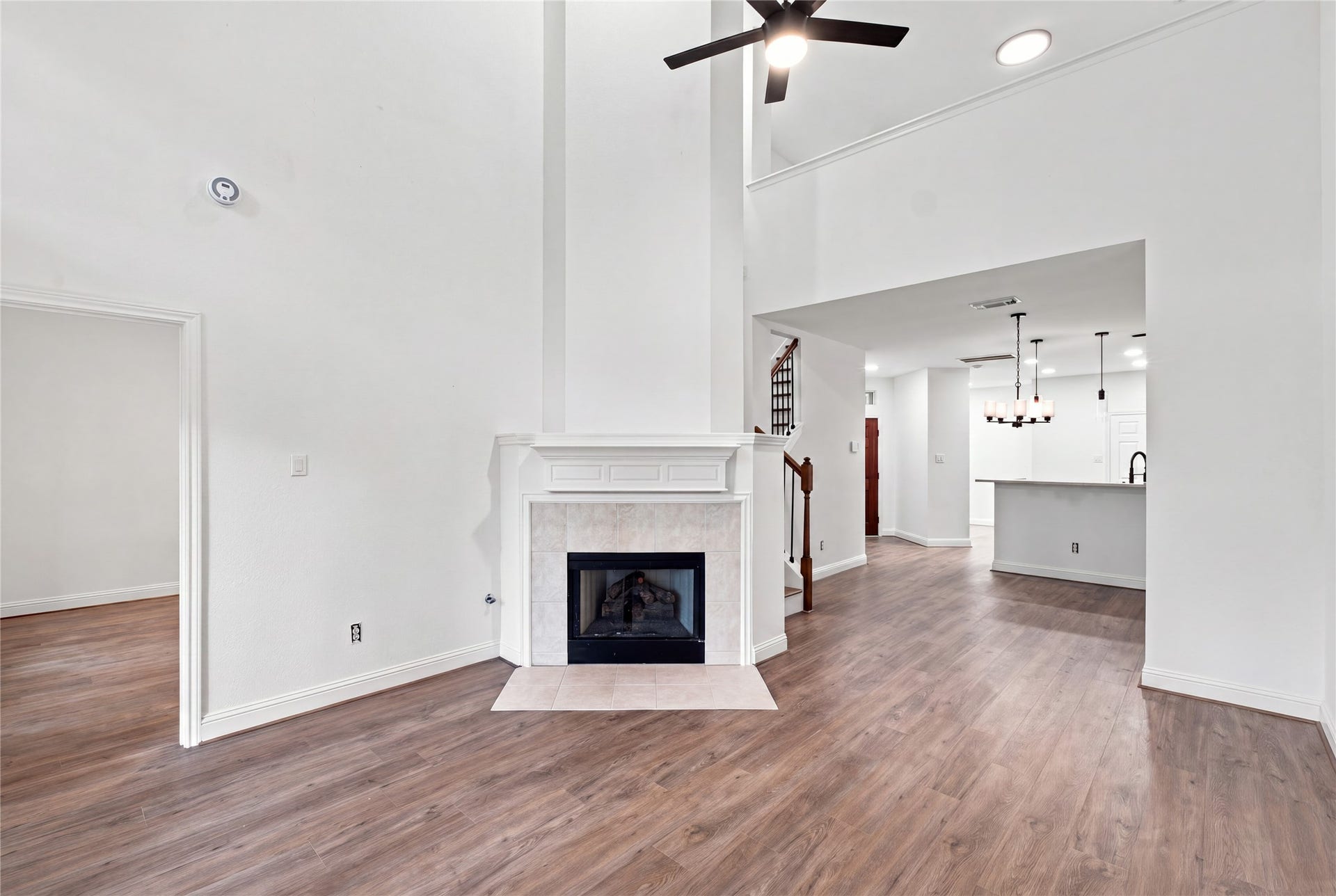 47 Alderon Woods Place, Spring, TX 77382 Two-story living room with a fireplace and upstairs overlook.