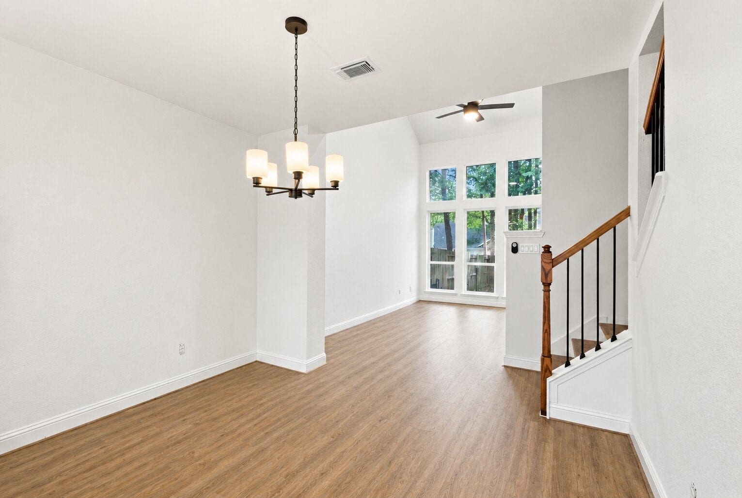 47 Alderon Woods Place, Spring, TX 77382 Step inside to an open living and dining area with high ceilings, wood-look flooring and plenty of natural light.