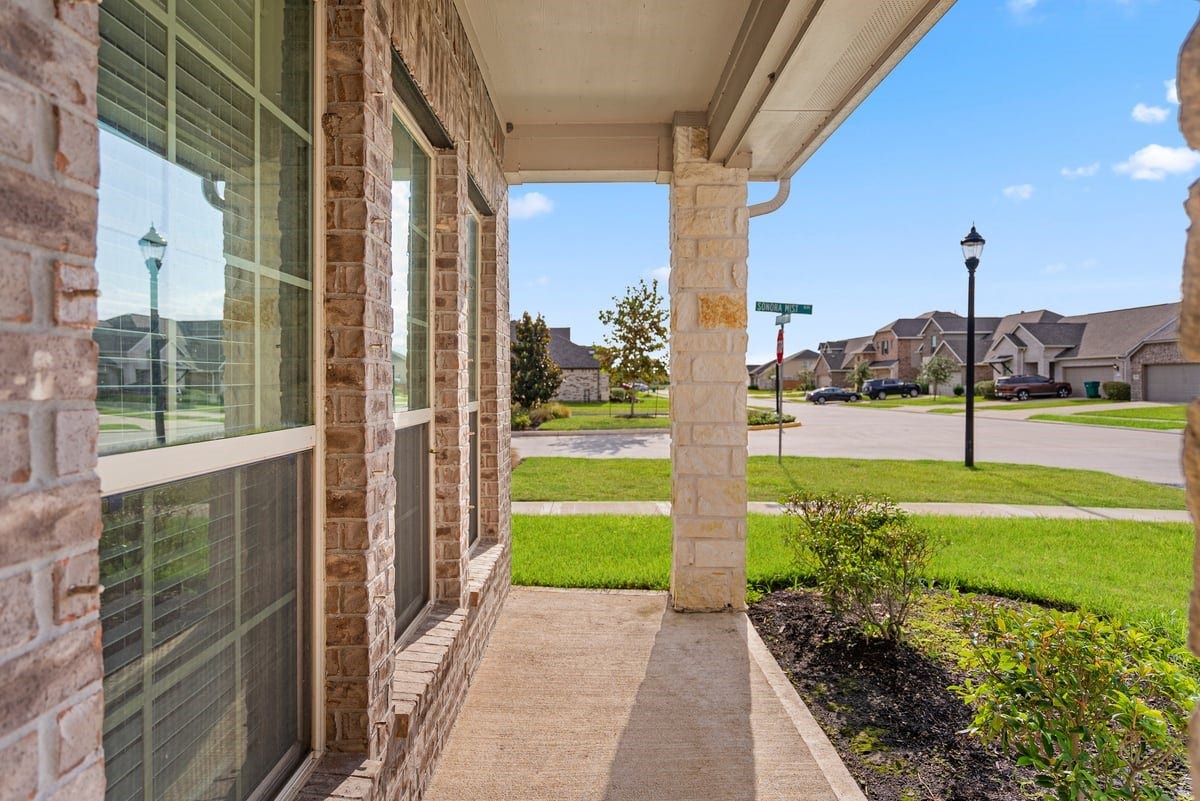 1702 Darwin Cedar Drive, Rosharon, TX 77583 The covered front porch is a perfect place to enjoy an afternoon and wave hi to neighbors passing by!