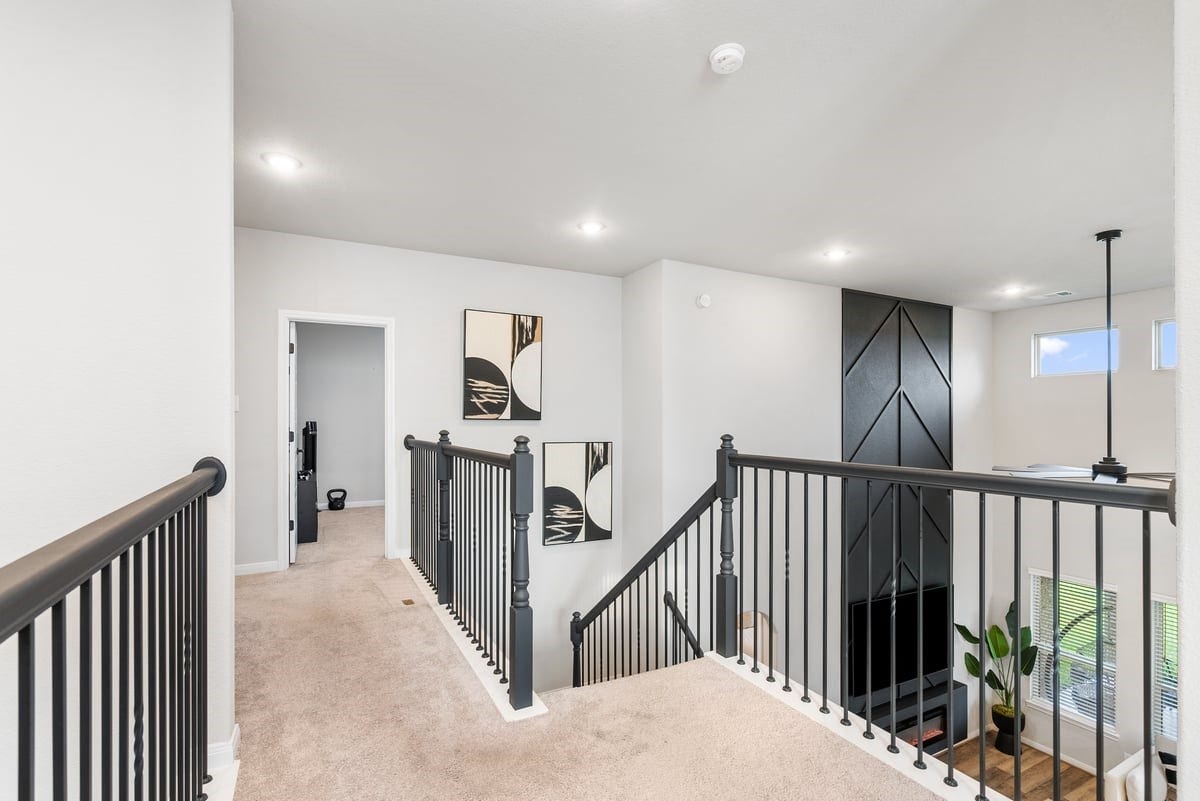 1702 Darwin Cedar Drive, Rosharon, TX 77583 Black rod iron railing lead you to the masterfully designed second floor!