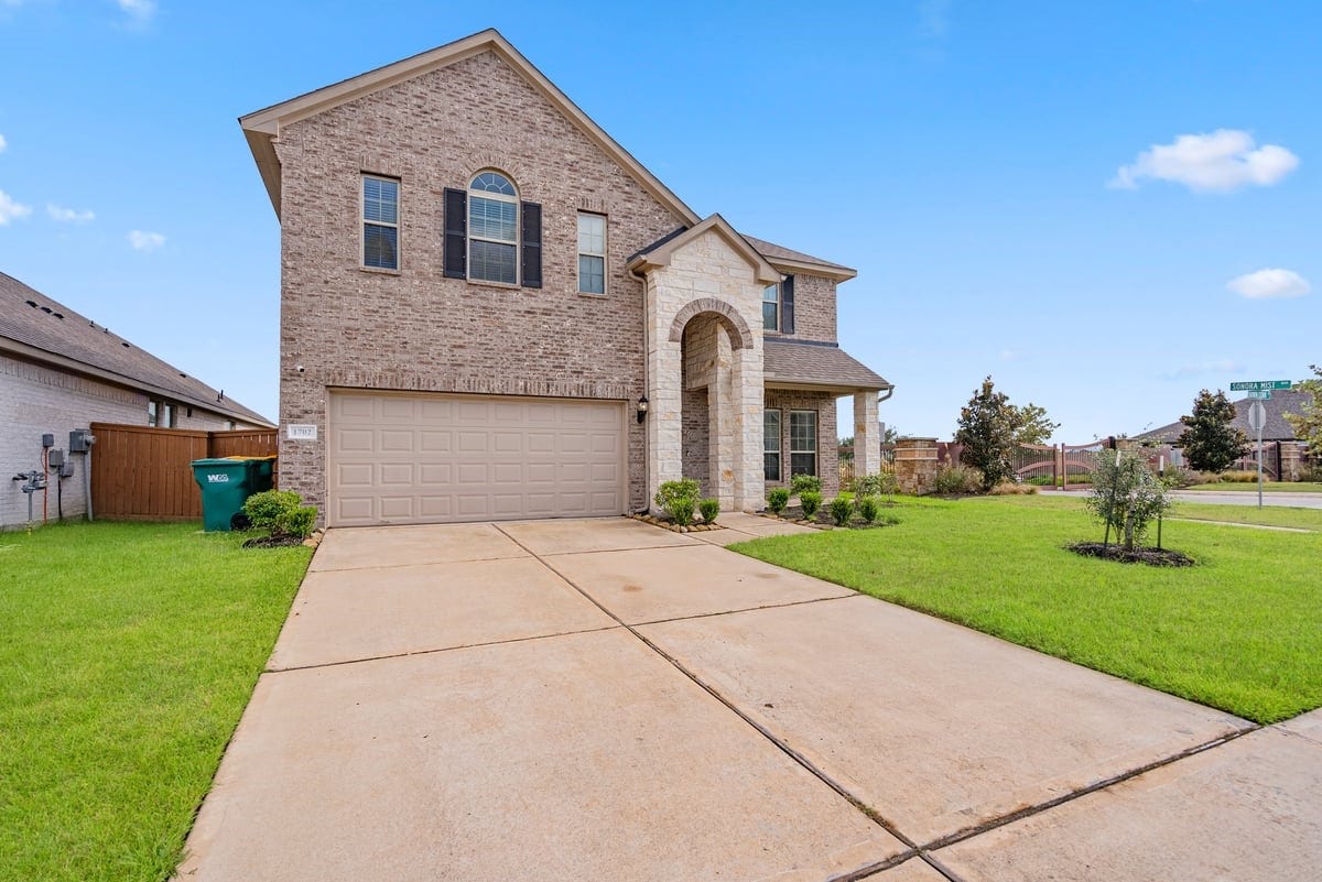 1702 Darwin Cedar Drive, Rosharon, TX 77583 Double wide driveway leads to a private garage, giving you plenty of space for parking and storage!