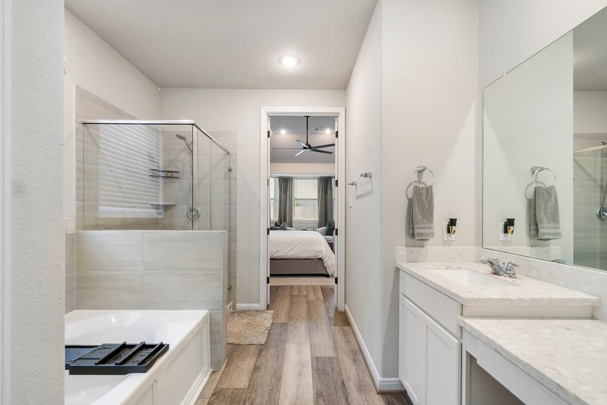 1702 Darwin Cedar Drive, Rosharon, TX 77583 Why go to the spa when your primary bath looks like this?! Bright neutral paint compliments the modern tile and counter design!