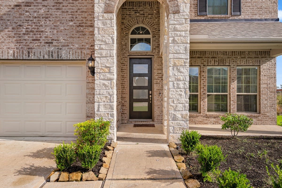 1702 Darwin Cedar Drive, Rosharon, TX 77583 The modern design starts from the front of the home with an oversized glass door!