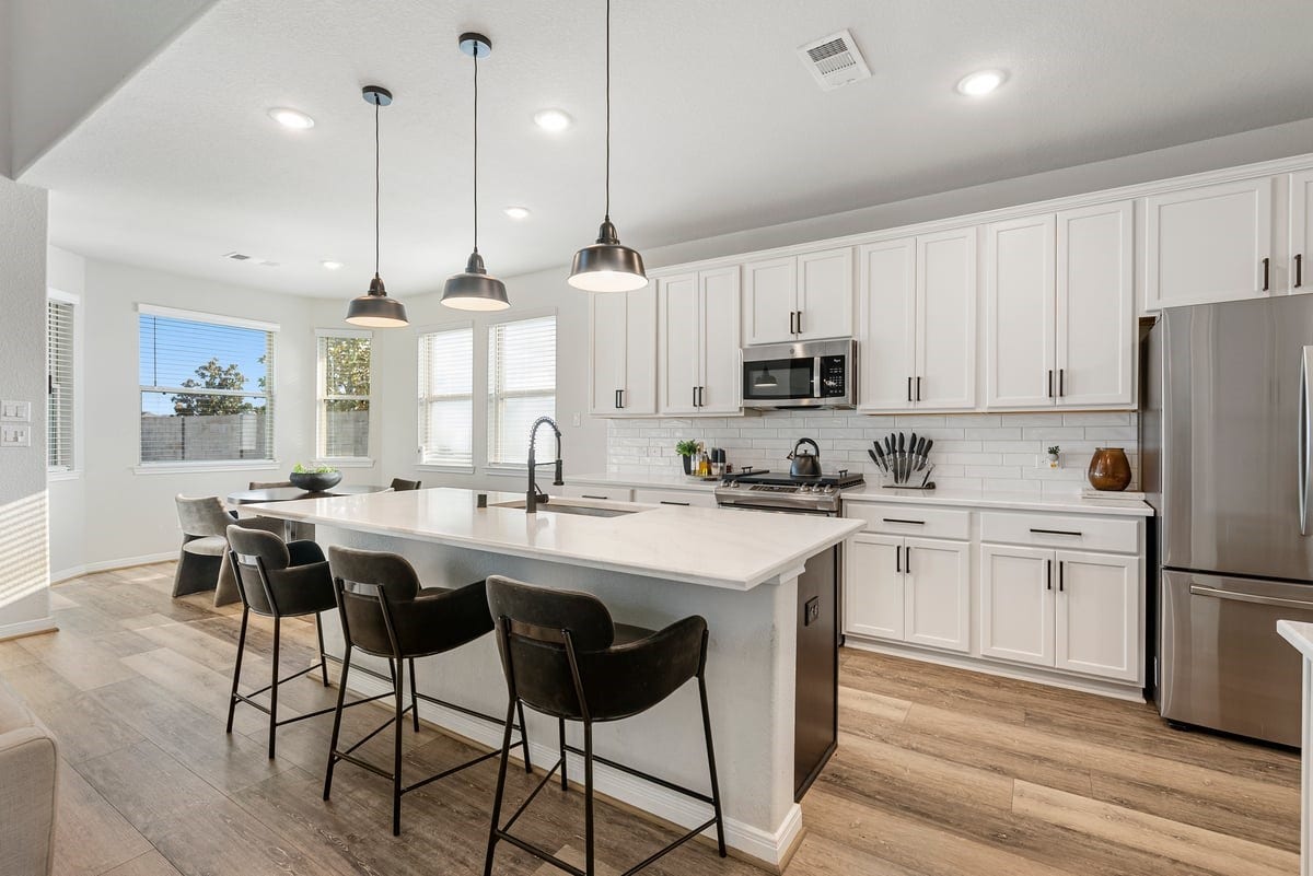 1702 Darwin Cedar Drive, Rosharon, TX 77583 Never miss a minute of the action with this open concept living room and kitchen design! The upgrades continue with elegant pendant lighting and quartz counters!