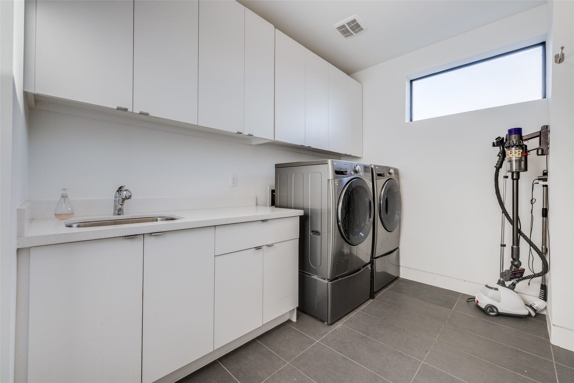 2014 Park Street, Houston, TX 77019 Second floor laundry, tile floor, washer & dryer included in sales price, sink for cleaning sports kits etc, lots of storage cabinets