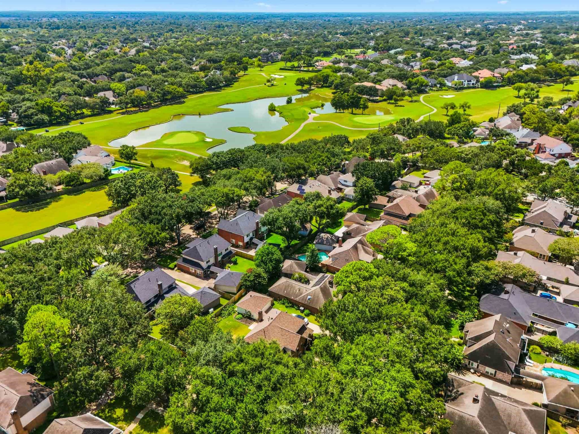 3926 Felicia Drive, Sugar Land, TX 77479 Scenic aerial view highlighting the beautiful Sweetwater golf course, water features and surrounding community.