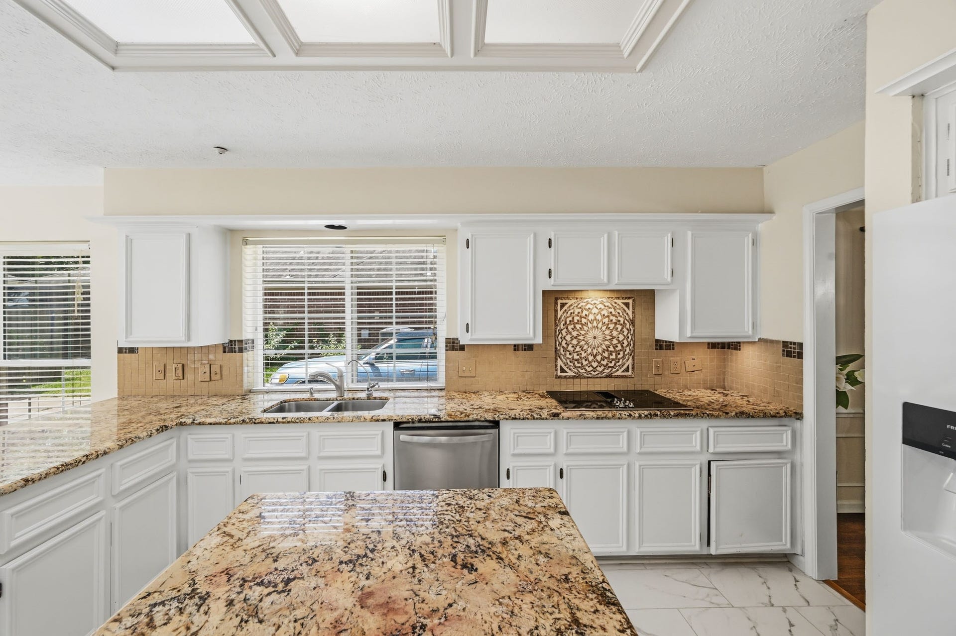 3926 Felicia Drive, Sugar Land, TX 77479 Generous counter space, white cabinetry and granite surfaces provide plenty of room for everyday meal prep.