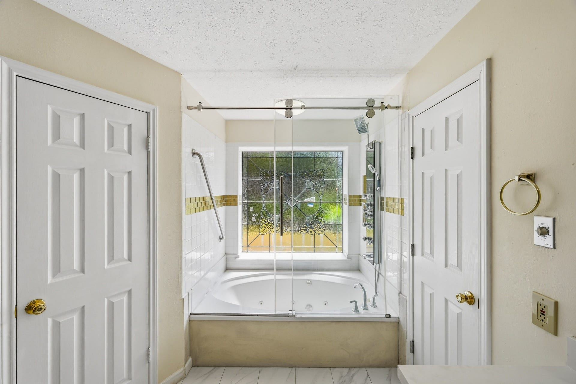 3926 Felicia Drive, Sugar Land, TX 77479 Jetted soaking tub, with shower wand, positioned beneath a decorative privacy window