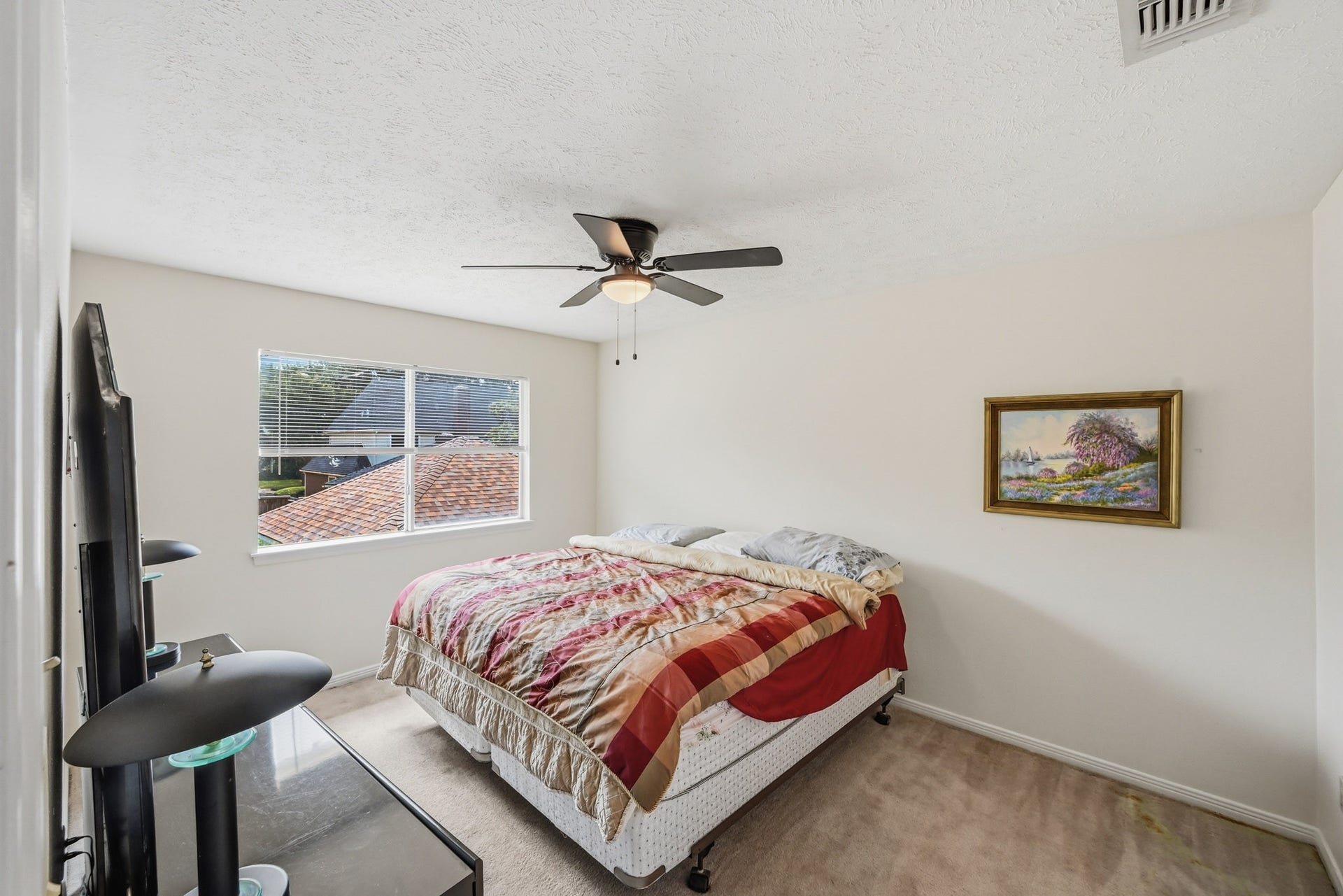 3926 Felicia Drive, Sugar Land, TX 77479 Spacious secondary bedroom with ceiling fan and natural light.