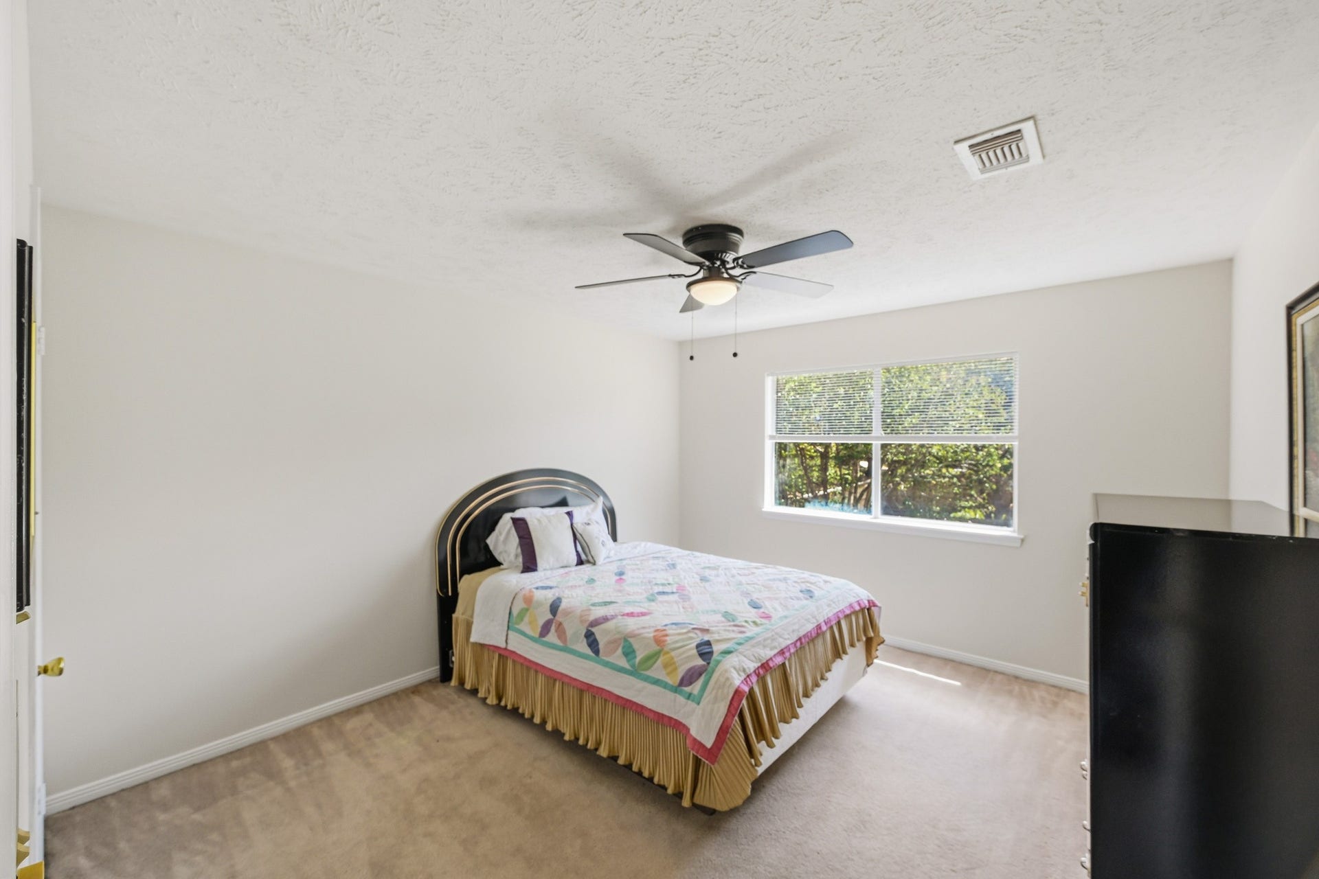 3926 Felicia Drive, Sugar Land, TX 77479 Bright secondary bedroom with ceiling fan, large window and ample space.