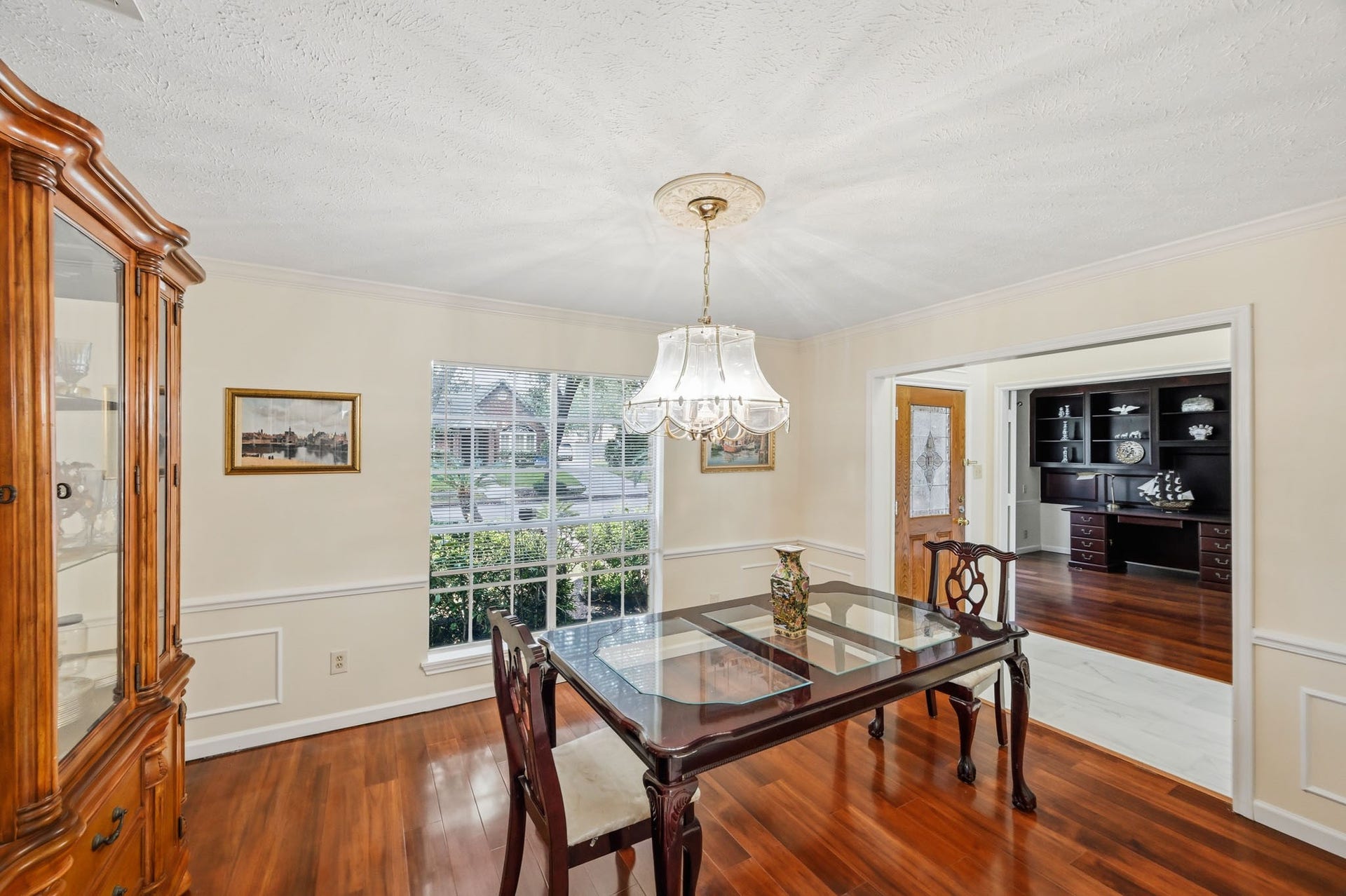 3926 Felicia Drive, Sugar Land, TX 77479 Elegant formal dining room with hardwood floors, decorative molding, and abundant natural light.