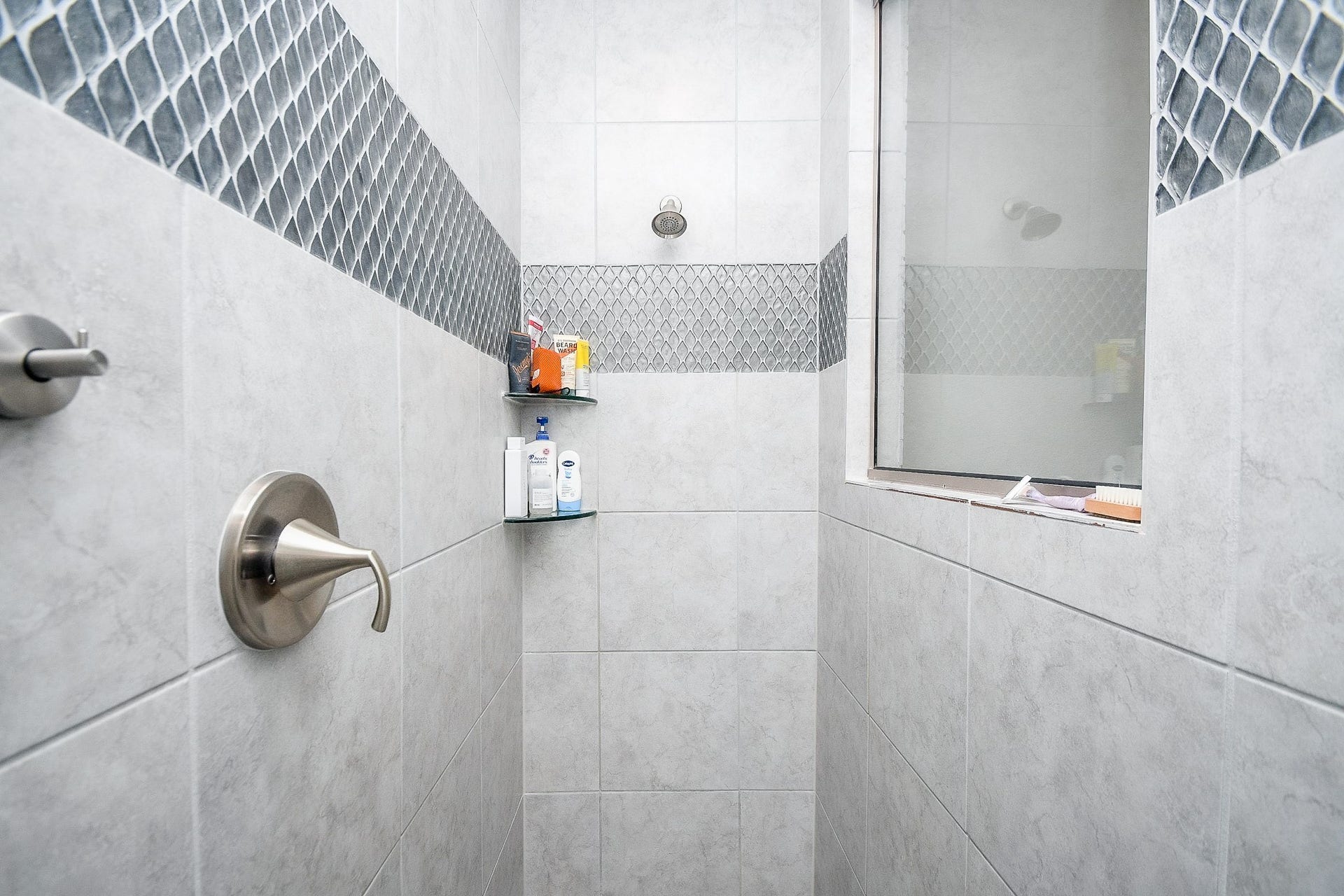 2703 Ripe Amber Cup Court, Richmond, TX 77406 Large walk-in shower with tile surround, accent tile detail.