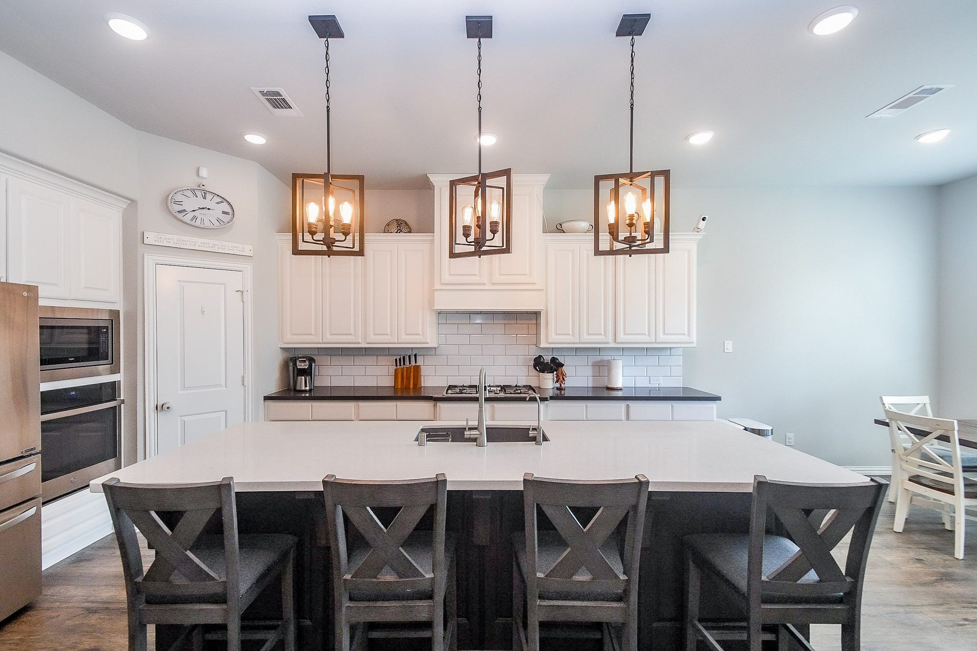 2703 Ripe Amber Cup Court, Richmond, TX 77406 Kitchen features a large island with breakfast bar seating, farmhouse sink and elegant custom pendant lighting. Elegan quartz countertops!