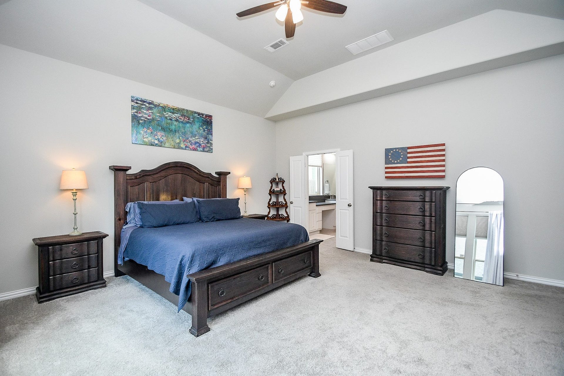 2703 Ripe Amber Cup Court, Richmond, TX 77406 Primary bedroom suite with gambrel ceiling, backyard-facing windows and direct access to the private bath.