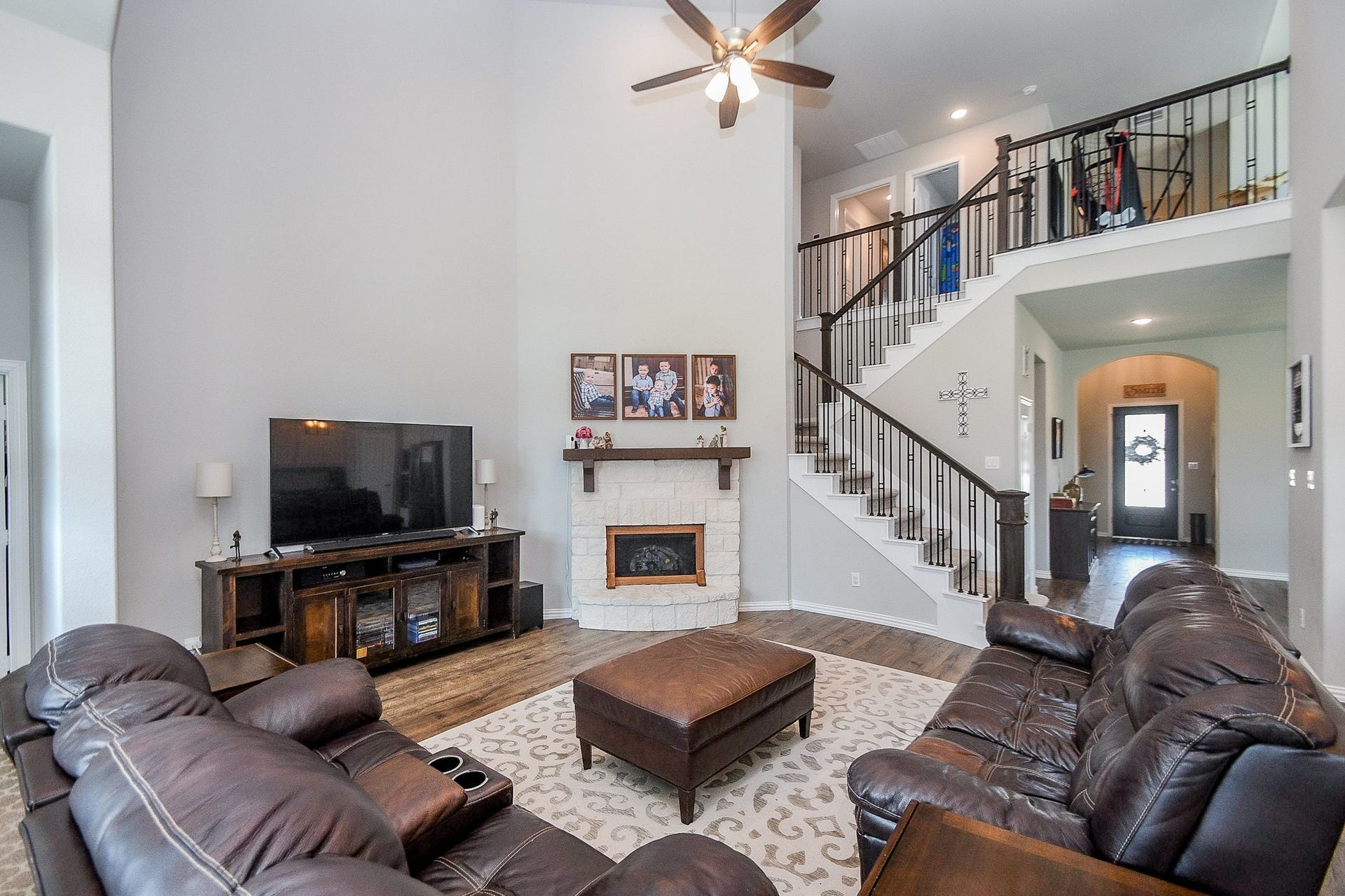 2703 Ripe Amber Cup Court, Richmond, TX 77406 Main living area with stone corner fireplace, open staircase and easy flow from the front entry into the heart of the home.