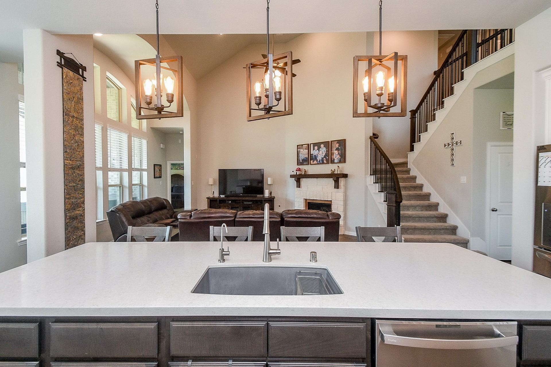 2703 Ripe Amber Cup Court, Richmond, TX 77406 View from the island highlights the granite farmhouse sink and open layout connecting the kitchen, family room and staircase.