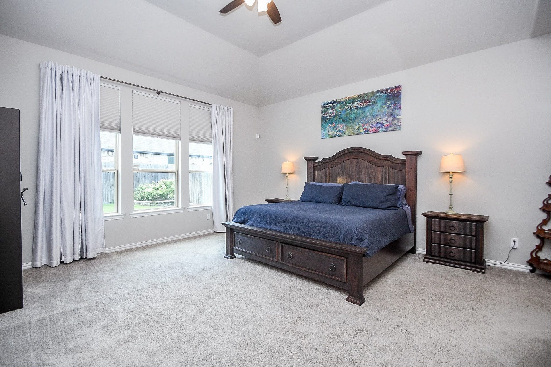 2703 Ripe Amber Cup Court, Richmond, TX 77406 Primary suite features a gambrel ceiling, large windows overlooking the backyard and a spacious layout.