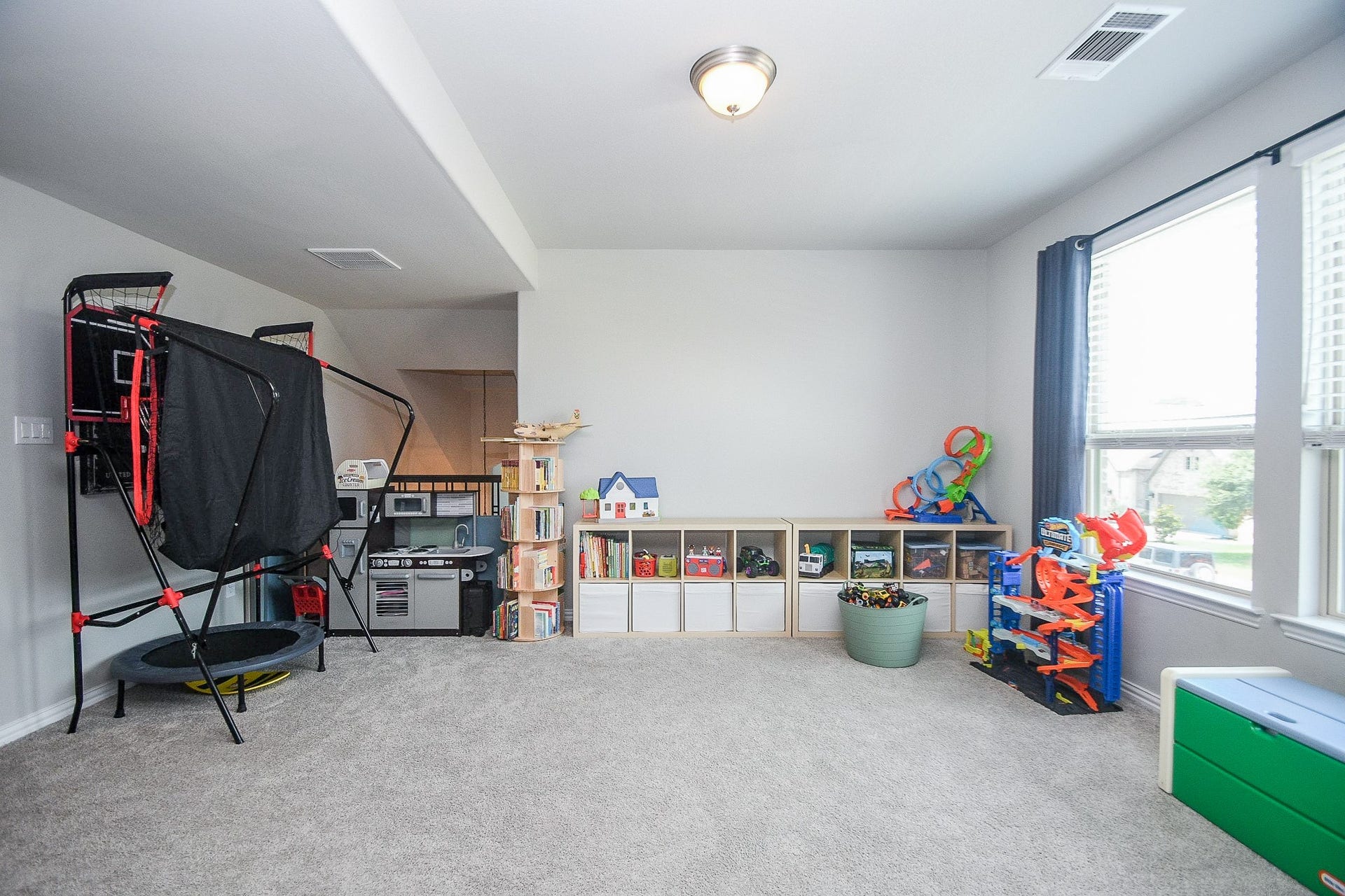 2703 Ripe Amber Cup Court, Richmond, TX 77406 Upstairs game room with large windows, open railing and flexible space for play, hobbies or additional living.