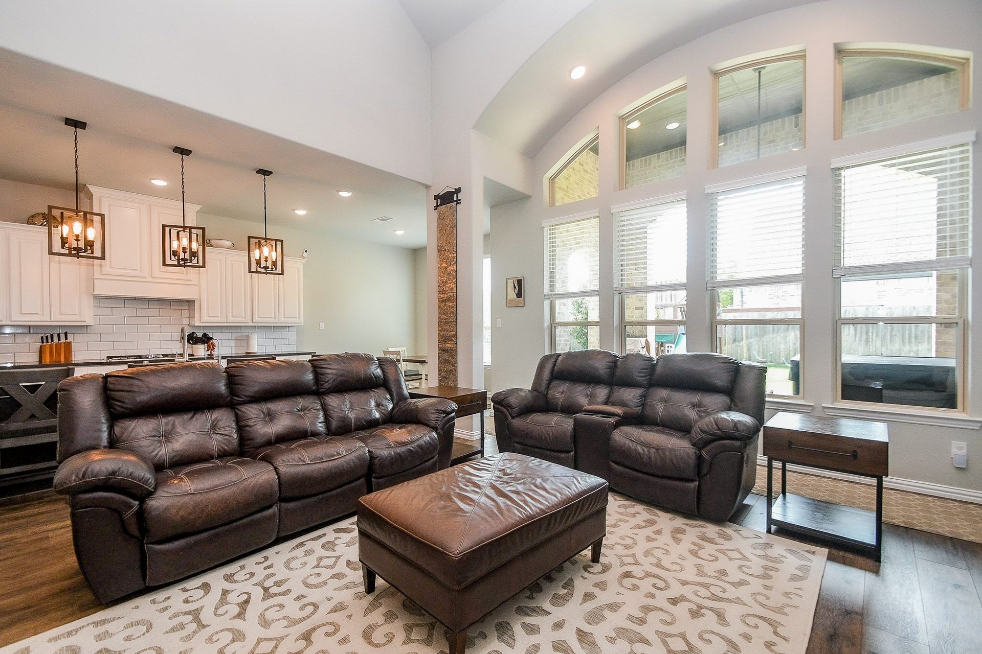 2703 Ripe Amber Cup Court, Richmond, TX 77406 Family room positioned beside the kitchen, with large windows overlooking the backyard and covered patio area.